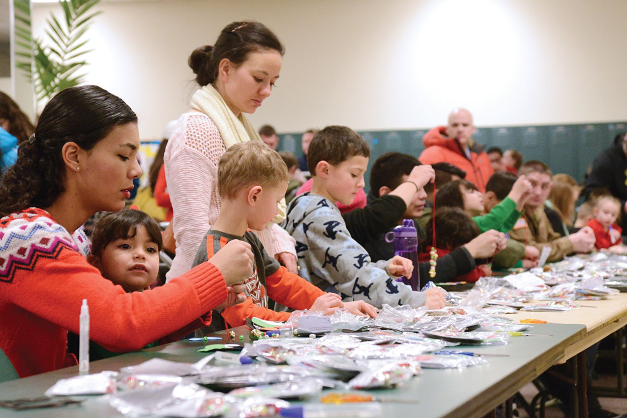 Families create crafts during Breakfast with Santa at the Arctic Oasis at Joint Base Elmendorf-Richardson, Alaska, Dec. 12, 2015. The most common craft created were tree decorations. The Arctic Oasis provided a breakfast, crafts, face painting, a photo booth and photo opportunity with Santa. (U.S. Air Force photo by Airman 1st Class Christopher R. Morales)