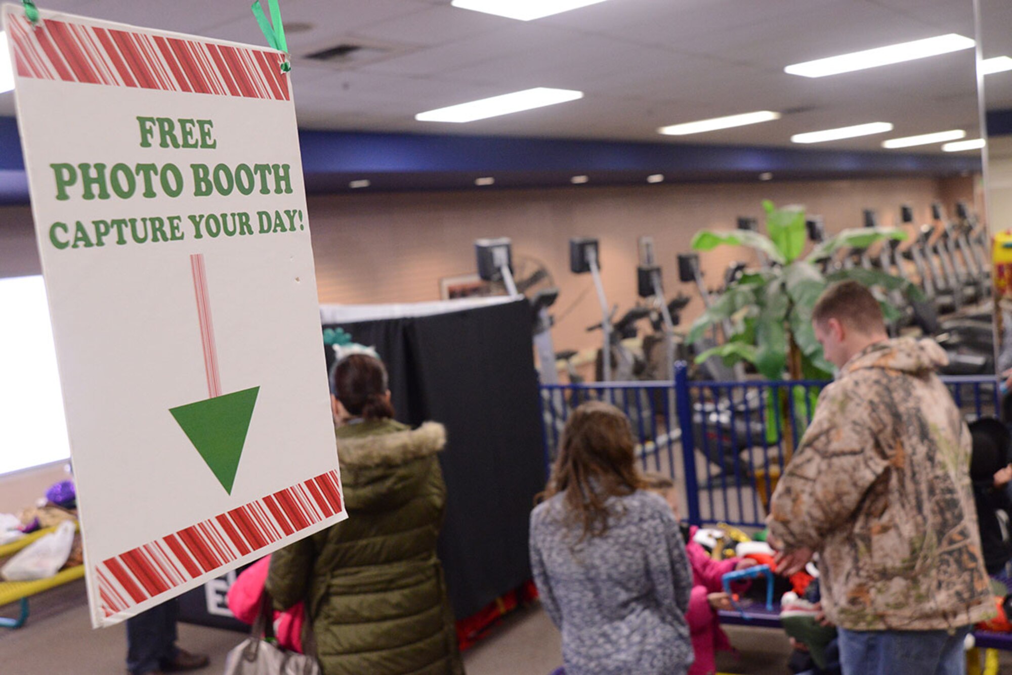 Families line up for a photo booth during Breakfast with Santa at the Arctic Oasis at Joint Base Elmendorf-Richardson, Alaska, Dec. 12, 2015. The photo booth provided many hats to make photos fun and festive. Breakfast with Santa provided a breakfast, crafts, face painting, a photo booth and photo opportunity with Santa. (U.S. Air Force photo by Airman 1st Class Christopher R. Morales)