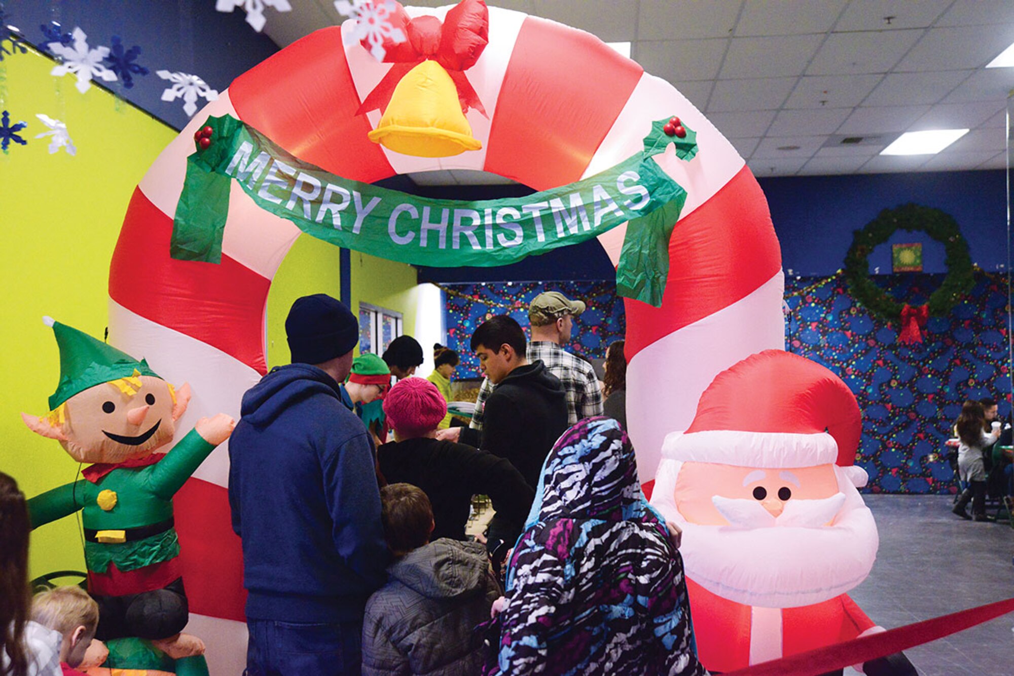Families wait in line for Breakfast with Santa at the Arctic Oasis at Joint Base Elmendorf-Richardson, Alaska, Dec. 12, 2015. Breakfast consisted of pancakes, bacon, apples, cereal and syrup. (U.S. Air Force photo by Airman 1st Class Christopher R. Morales)