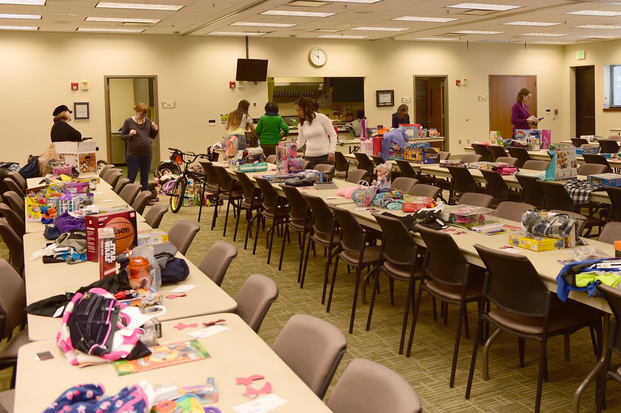 Members of the Buckley Spouses Group gather to prepare Angel Tree gifts for handout Dec. 17, 2015, at the chapel on Buckley Air Force Base, Colo. The Angel Tree is a program set up by the Buckley Spouses Group and Buckley First Sergeants that helps Airmen and their families provide gifts for their children when finances are tight. (U.S. Air Force photo by Airman 1st Class Luke W. Nowakowski/Released)
