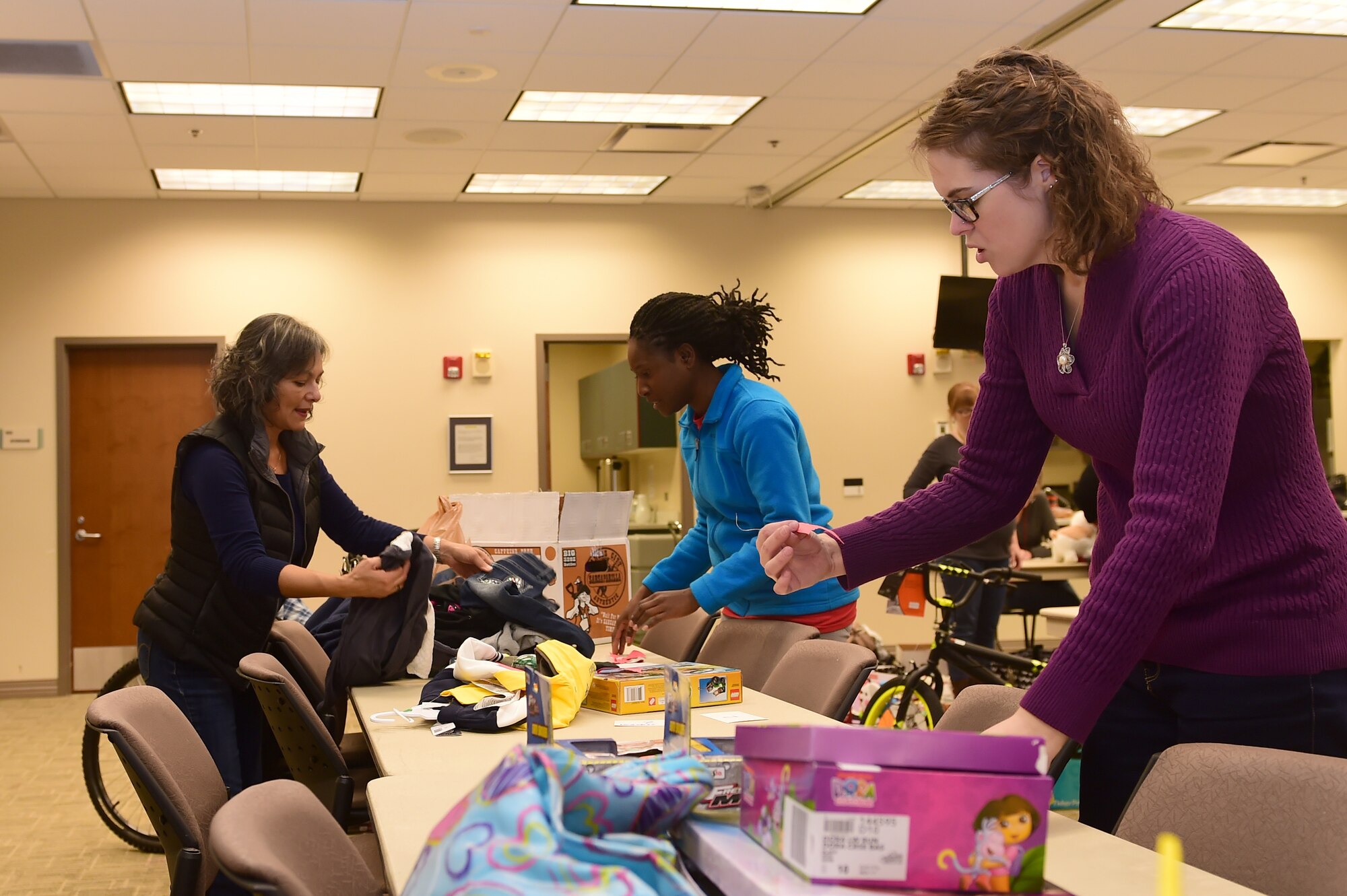 Members of the Buckley Spouses Group organize Angel Tree gifts Dec. 17, 2015, at the chapel on Buckley Air Force Base, Colo. The Angel Tree is a program set up by the Buckley Spouses Group and Buckley First Sergeants that helps Airmen and their families provide gifts for their children when finances are tight. (U.S. Air Force photo by Airman 1st Class Luke W. Nowakowski/Released)