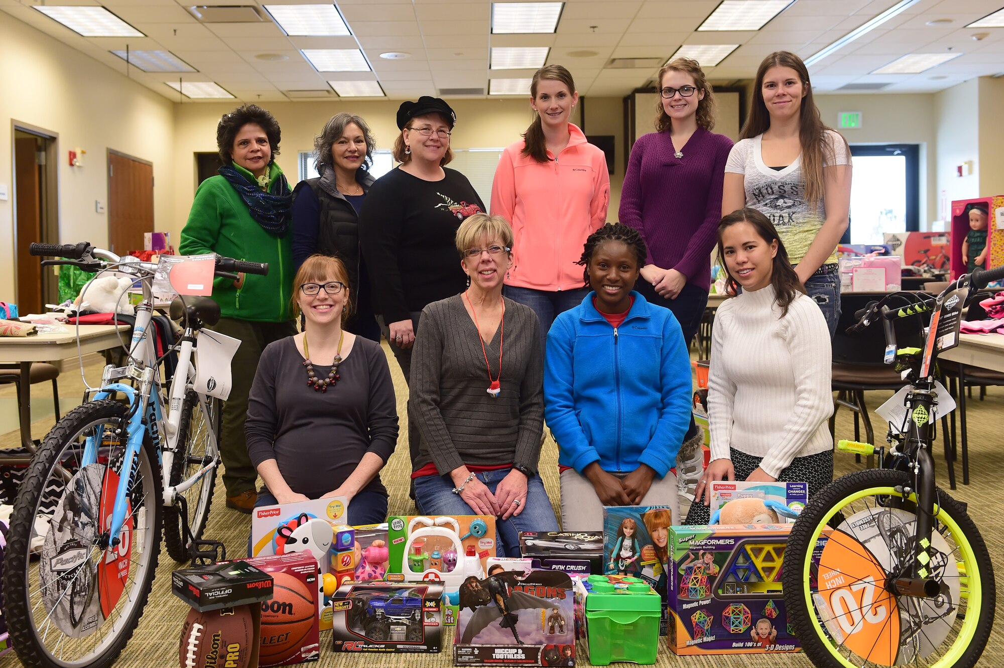 Members of the Buckley Spouses Group gather to prepare Angel Tree gifts for handout Dec. 17, 2015, at the chapel on Buckley Air Force Base, Colo. The Angel Tree is a program set up by the Buckley Spouses Group and Buckley First Sergeants that helps Airmen and their families provide gifts for their children when finances are tight. (U.S. Air Force photo by Airman 1st Class Luke W. Nowakowski/Released)