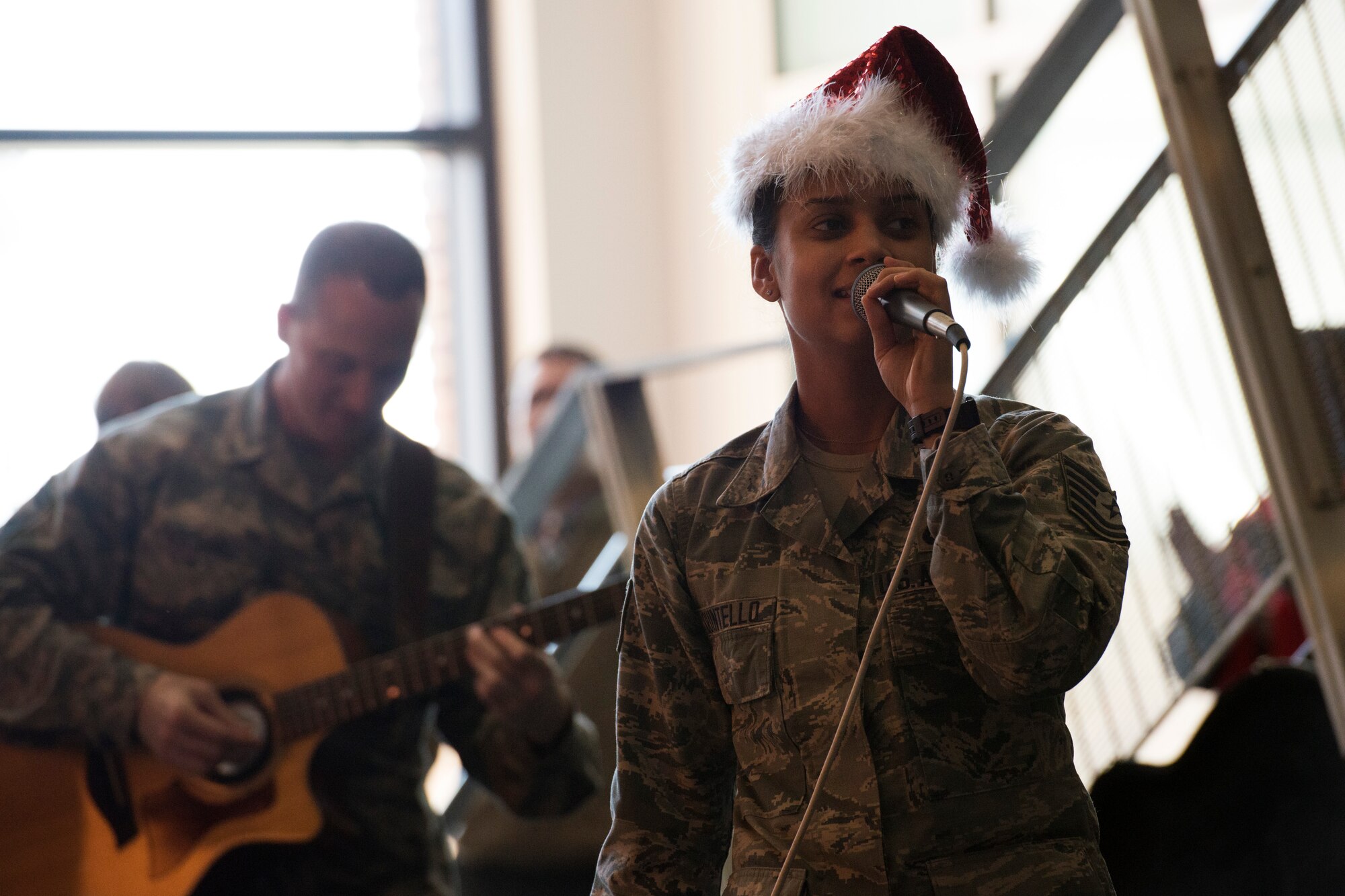 Tech. Sgt. Nalani Quintello, U.S. Air Force Band’s Max Impact vocalist, sings holiday carols in the lobby of the William A. Jones III building at Joint Base Andrews, Md., Dec. 16, 2015. Max Impact played a surprise performance for the military members and civilians that work in the Jones building to spread holiday cheer. (U.S. Air Force photo by Airman 1st Class Philip Bryant/Released)