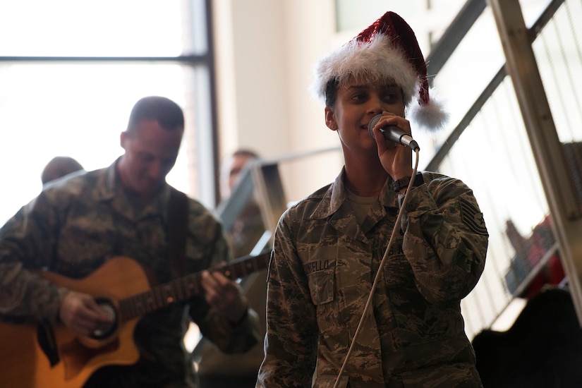 Tech. Sgt. Nalani Quintello, U.S. Air Force Band’s Max Impact vocalist, sings holiday carols in the lobby of the William A. Jones III building at Joint Base Andrews, Md., Dec. 16, 2015. Max Impact played a surprise performance for the military members and civilians that work in the Jones building to spread holiday cheer. (U.S. Air Force photo by Airman 1st Class Philip Bryant/Released)