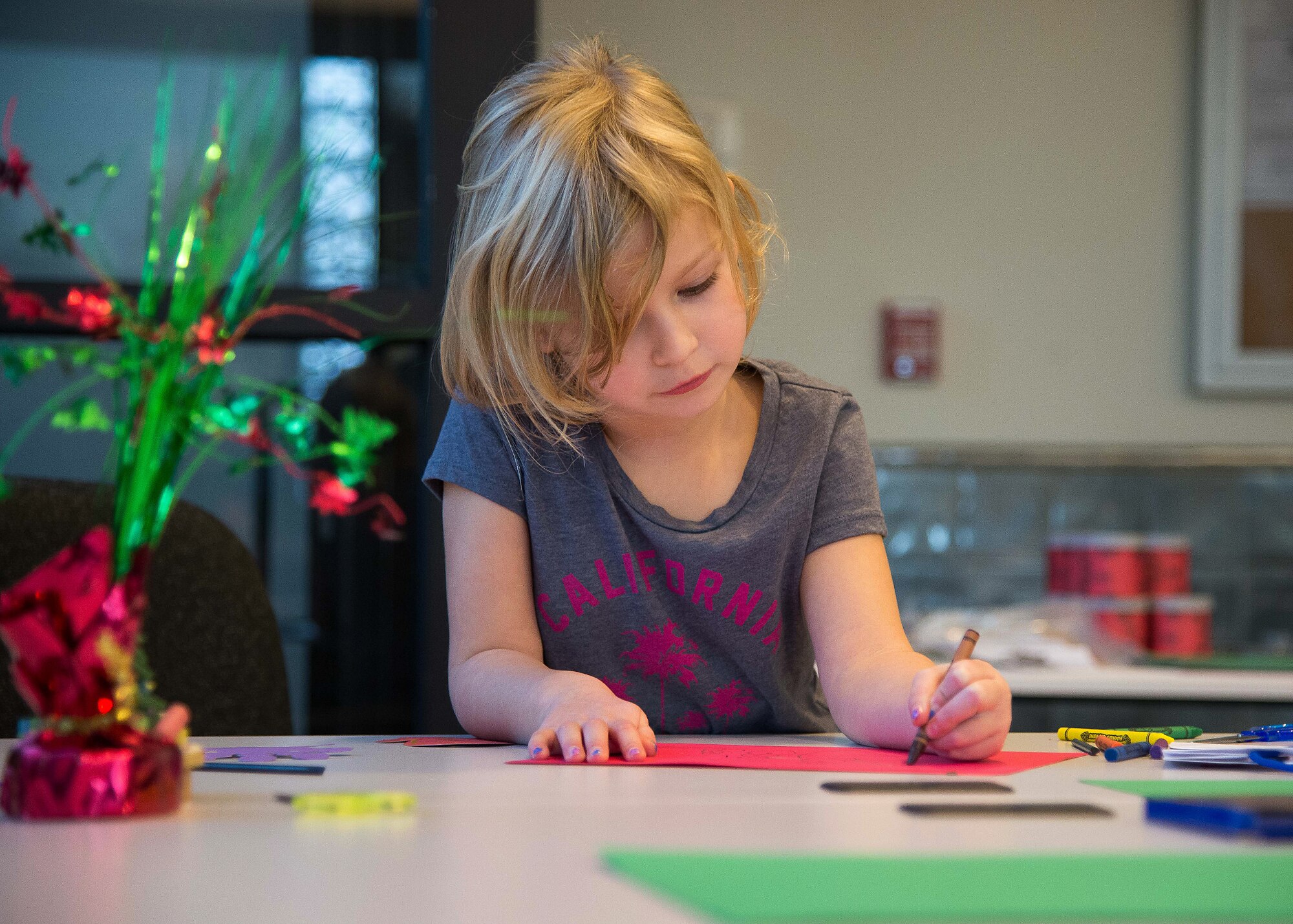 Josslyn Higbee, age 6, draws on a piece of paper during a Holiday Craft Making event at the Information Learning Center Dec.16. The holiday event was hosted by the ILC as part of their support to the military community. (U.S. Air Force photo by Mark Herlihy)