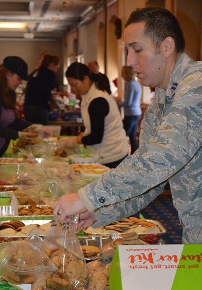 Volunteers sort cookies into bags during the Kirtland Spouses' Club annual cookie drive. More than 10,000 cookies were donated to be packaged and delivered to Airmen living in the dorms. (Photo by Maria Conway)
