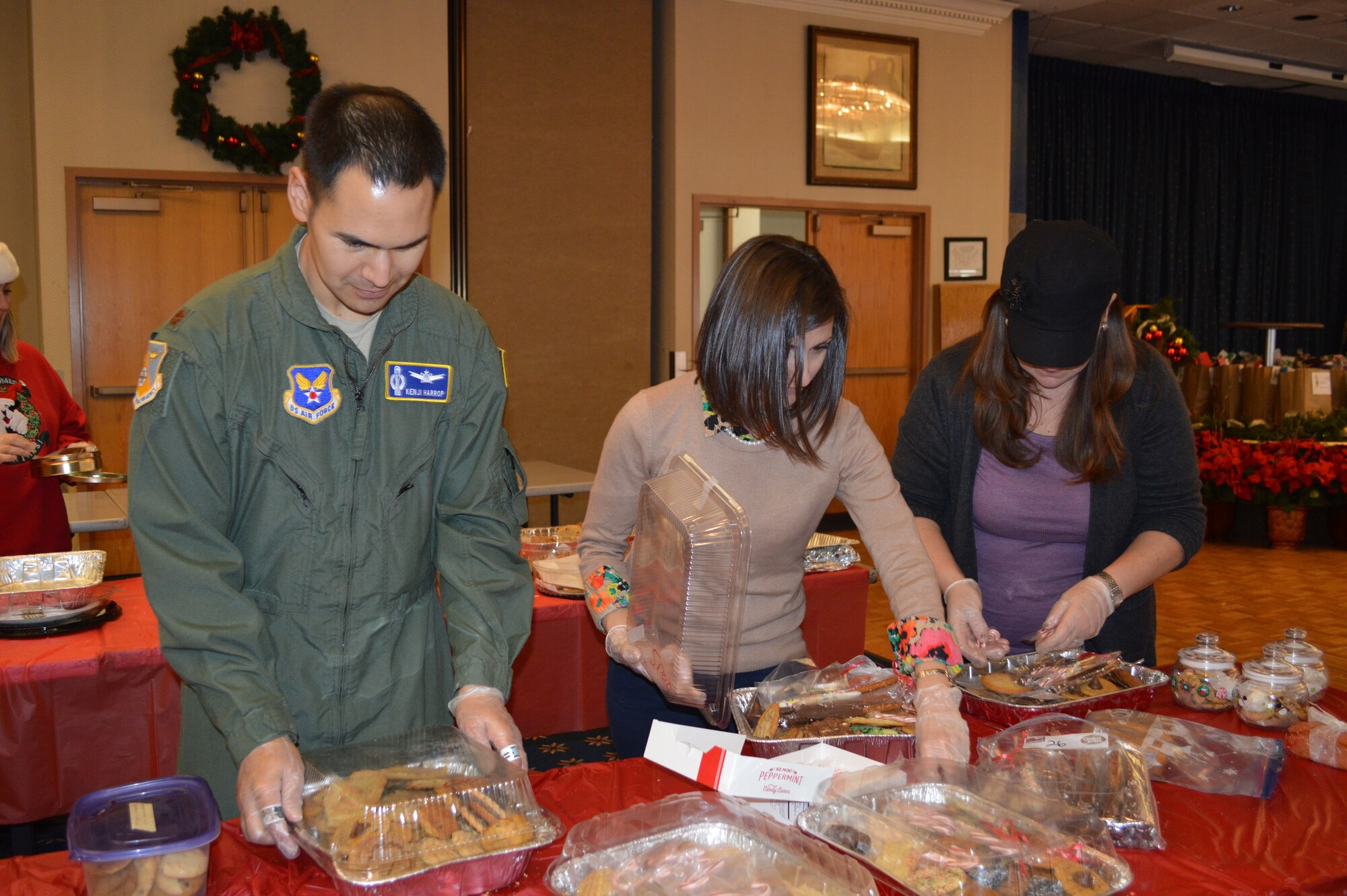 Volunteers sort cookies into bags during the Kirtland Spouses' Club annual cookie drive. More than 10,000 cookies were donated to be packaged and delivered to Airmen living in the dorms. (Photo by Maria Conway)