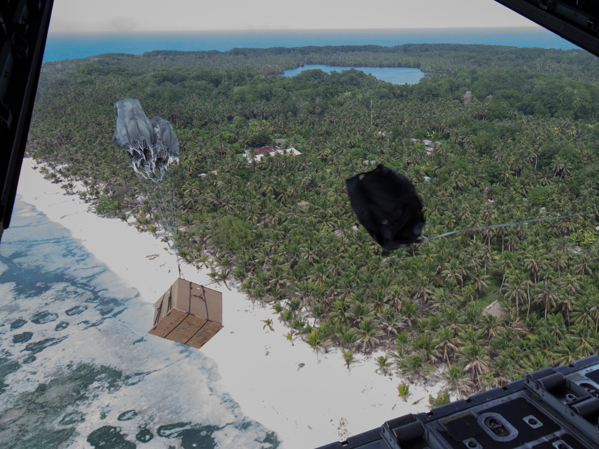 A low-cost low-altitude bundle of donated goods drops to Pulusuk, Federated States of Micronesia, Dec. 13, 2015, during Operation Christmas Drop. Operation Christmas Drop allows the 374th Airlift Wing and international partners from the Japan Air Self-Defense Force and Royal Australian Air Force to practice dynamic delivery airdrop with unsurveyed drop zones while providing critical supplies to 20,000 islanders. (U.S. Air Force photo by Osakabe Yasuo/Released)