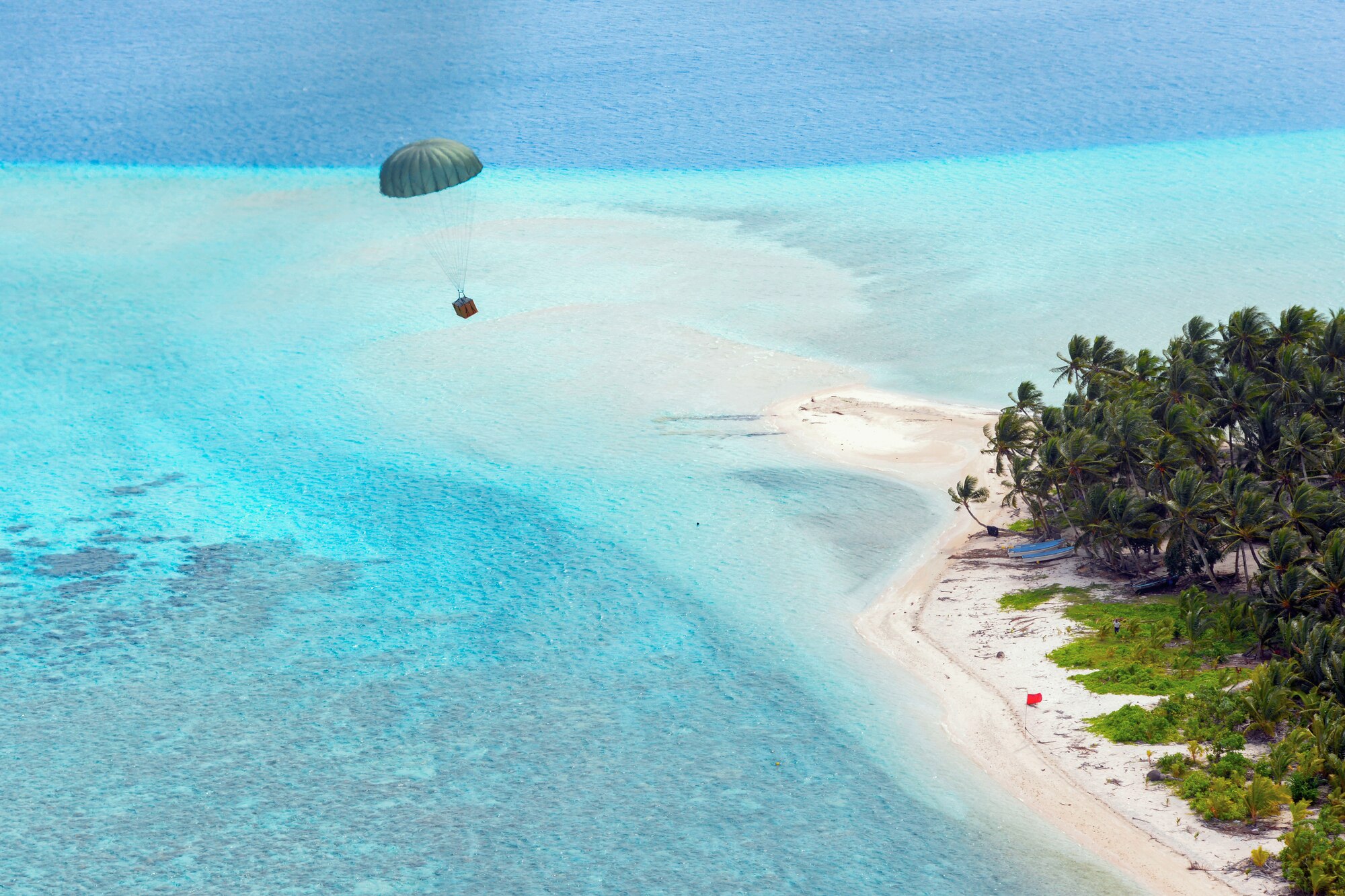 A C-130 Hercules from Yokota Air Base, Japan, drops a low-cost, low-altitude bundle over the Federated States of Micronesia during Operation Christmas Drop Dec.13, 2015. Operation Christmas Drop is the Department of Defense`s longest running humanitarian mission covering 56 remote islands in Micronesia. This is the first year the Royal Australian Air Force and Japan Air Self-Defense Force have participated in the drops.(U.S. Air Force photo by Tech. Sgt. Melissa K. Mekpongsatorn)
