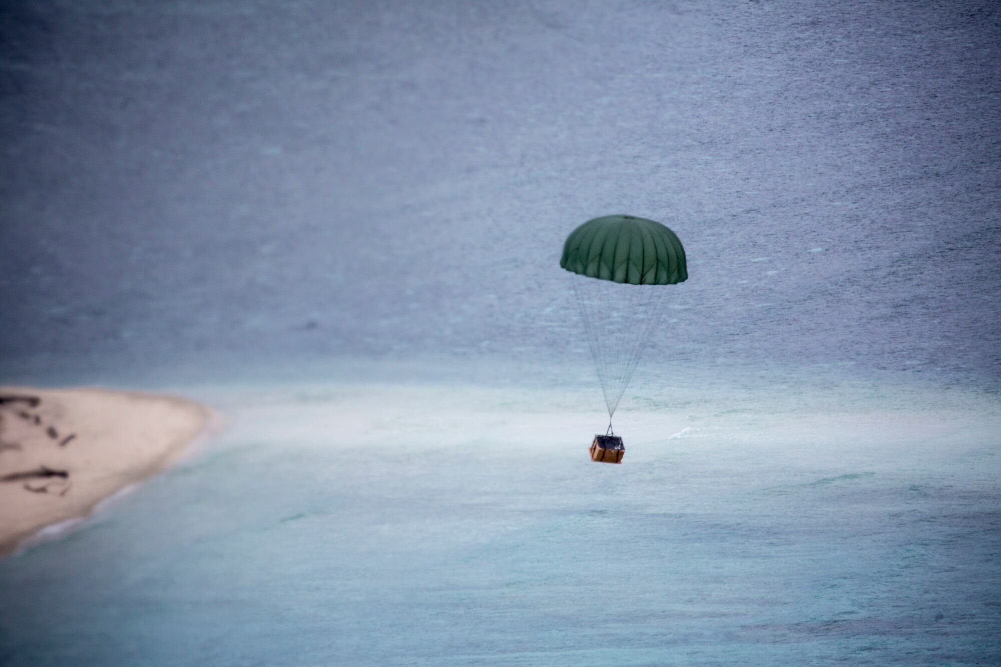 A low-cost low-altitude bundle of donated goods drops to Ngulu island, Federated States of Micronesia, Dec. 11, 2015, during Operation Christmas Drop. Operation Christmas Drop allows the 374th Airlift Wing and international partners from the Japan Air Self-Defense Force and Royal Australian Air Force to practice dynamic delivery airdrop with unsurveyed drop zones while providing critical supplies to 20,000 islanders. (U.S. Air Force photo by Osakabe Yasuo/Released)
