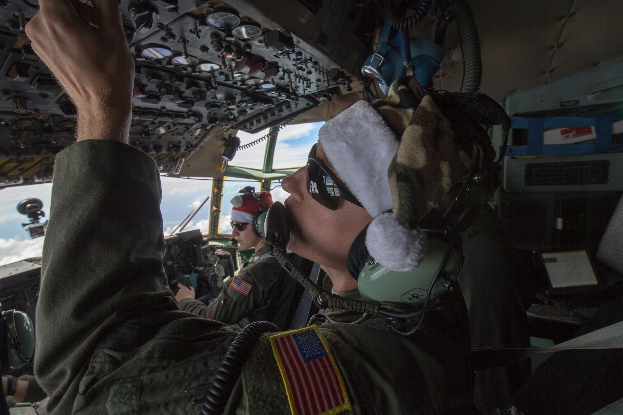 Staff Sgt. Travis Livingston, 36th Airlift Squadron flight engineer, checks instruments over the Pacific Ocean, Dec. 11, 2015, during Operation Christmas Drop.  Every December, C-130H Hercules aircrews from Yokota head to Andersen Air Force Base to execute low-cost, low-altitude humanitarian airdrops to islanders throughout the Commonwealth of the Northern Marianas, Federated States of Micronesia, Republic of Palau. These islands are some of the most remote locations on the globe spanning a distance nearly as broad as the continental U.S. It is the longest-running Department of Defense humanitarian airdrop operation with 2015 being the first trilateral execution with support from Japan Air Self-Defense Force and Royal Australian Air Force. (U.S. Air Force photo by Osakabe Yasuo/Released)