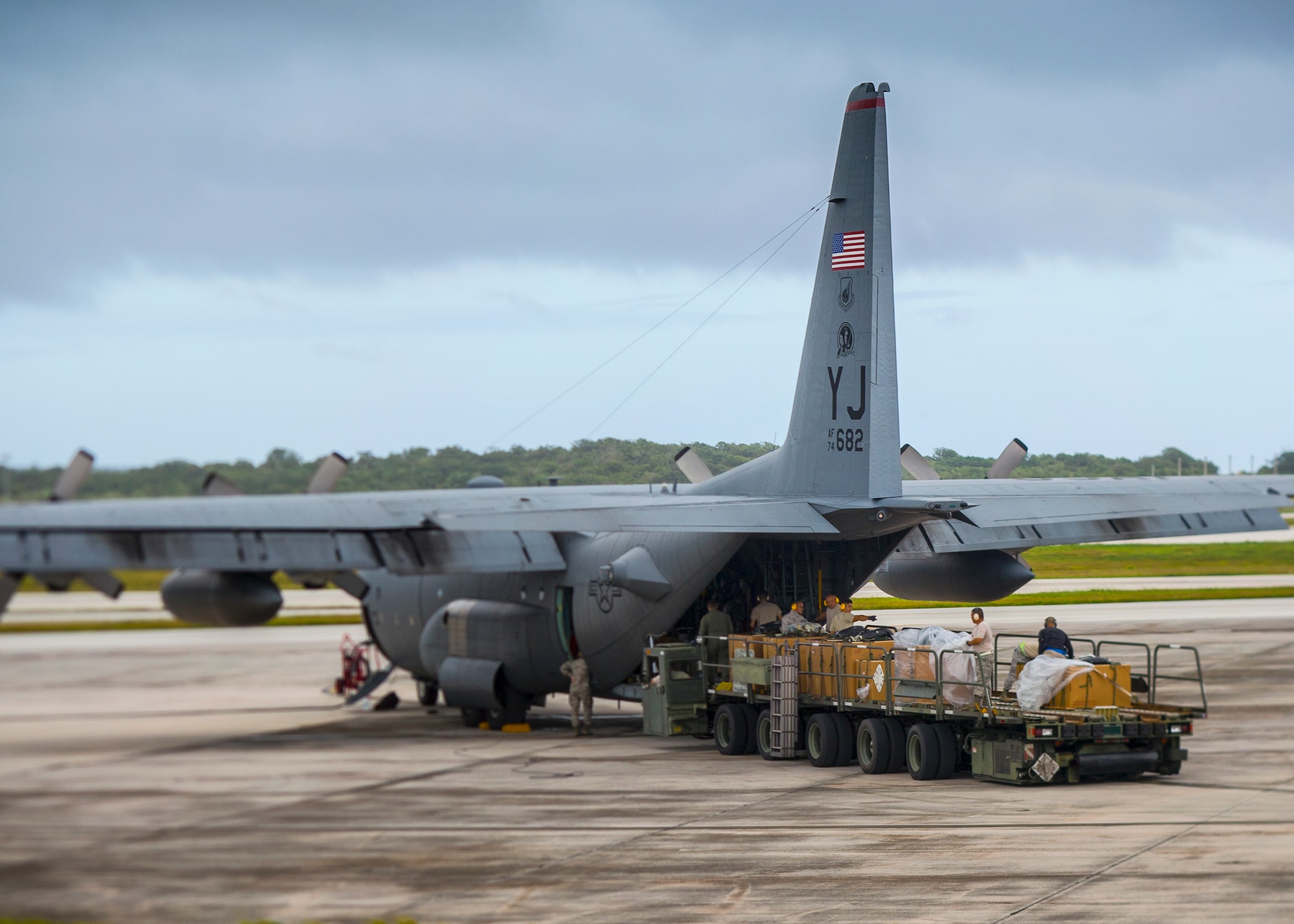 Combat mobility riggers from the 374th Logistics Readiness Squadron load low-cost low-altitude bundles onto a C-130 Hercules at Andersen Air Force Base, Guam, Dec. 10, 2015, during Operation Christmas Drop 2015. This year marks the 64th year of Operation Christmas Drop, and the first trilateral execution of Department of Defense's longest running humanitarian airdrop mission with support from Royal Australian Air Force and Japan Air Self-Defense Force C-130 aircrews. (U.S. Air Force photo by Osakabe Yasuo/Released)