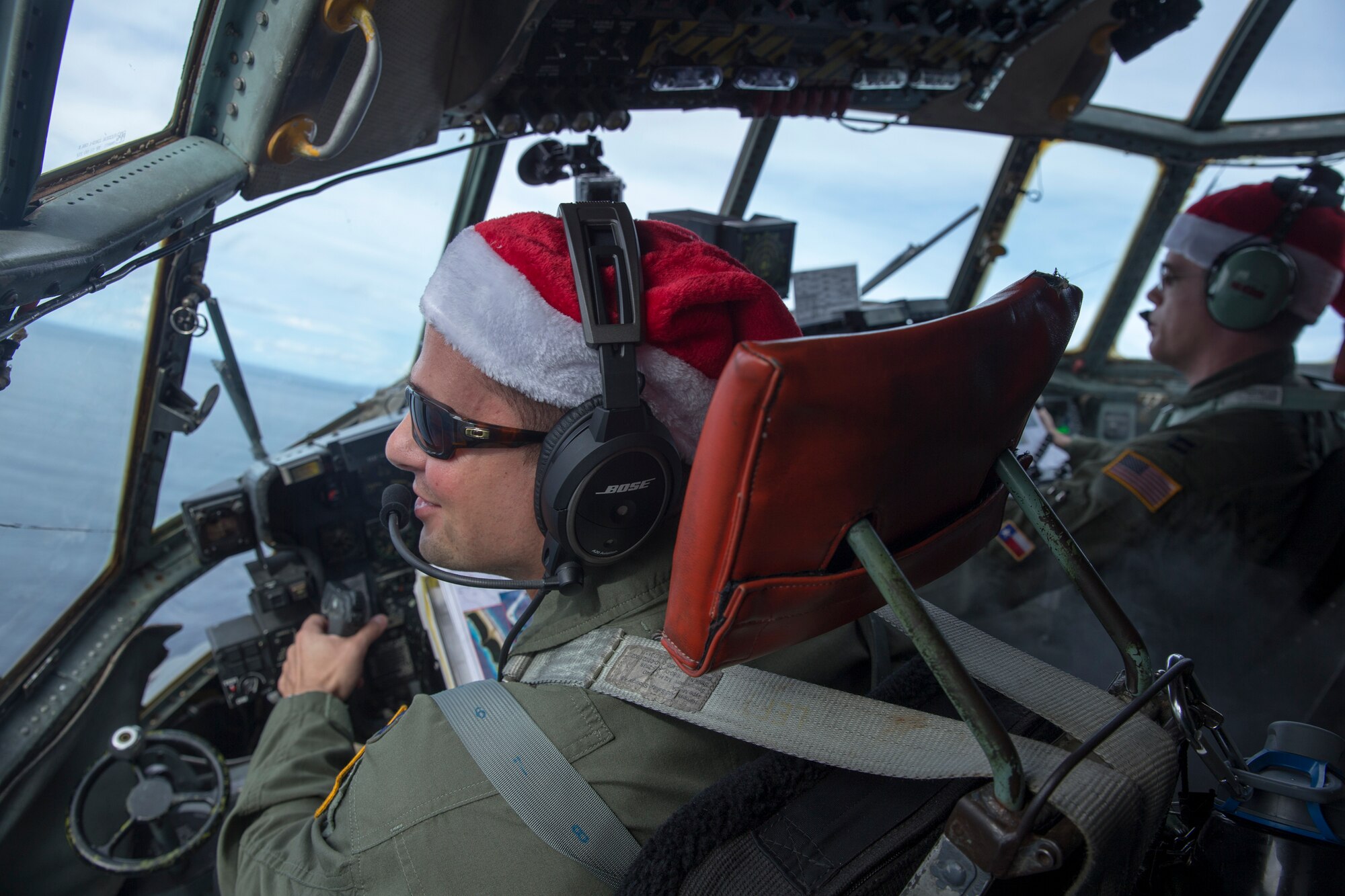 Crew members with the 36th Airlift Squadron fly over Ettal Atoll, Federated States of Micronesia, Dec. 9, 2015, during Operation Christmas Drop. This is a Humanitarian Aid/Disaster Relief training event where C-130 aircrews perform low-cost low-altitude airdrops on unsurveyed drop zones while providing critical supplies to 56 islands throughout the Commonwealth of the Northern Marianas, Federated States of Micronesia and Republic of Palau. It highlights the U.S. and allied airpower capabilities to orient and respond to activities in peacetime and crisis. In addition to delivering critical supplies to those in need, Operation Christmas Drop provides specific training to U.S. and allied aircrews, enabling theater-wide airpower. (U.S. Air Force photo by Osakabe Yasuo/Released)