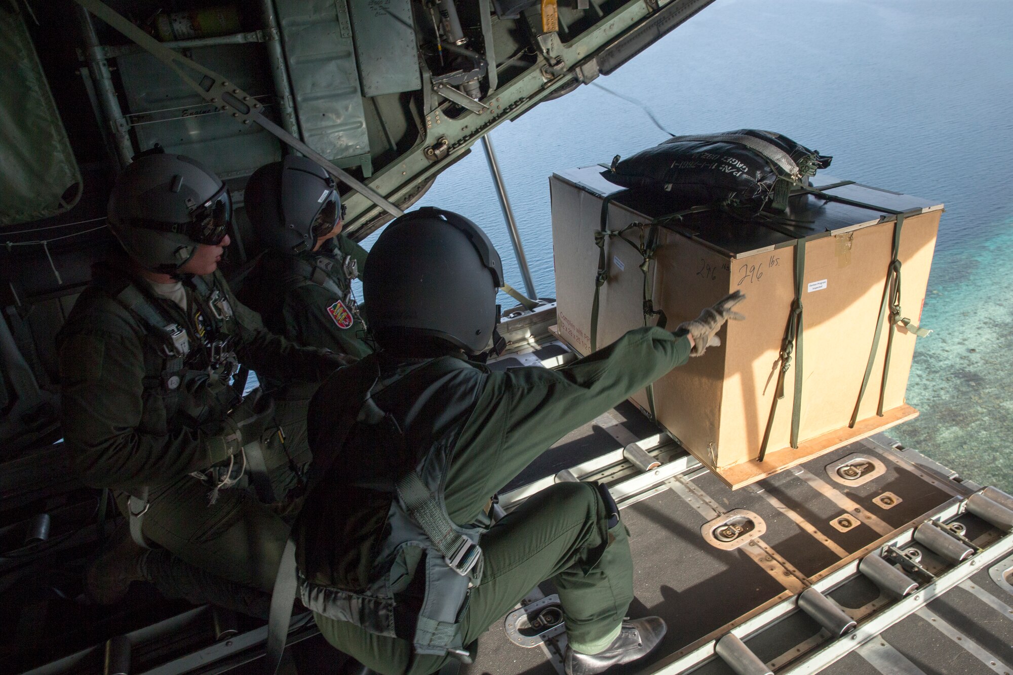 Airmen with the Japan Air Self-Defense Force and U.S. Air Force drop a low-cost, low-altitude bundle to Lukunor Atoll, Federated Sates of Micronesia, Dec. 9, 2015, during Operation Christmas Drop. This year marks the first time allied partners from JASDF and Royal Australian Air Force joined the U.S. in the Humanitarian Aid/Disaster Relief training event. During the training missions, C-130 aircrews perform low-cost low-altitude airdrops on unsurveyed drop zones while providing critical supplies to 56 islands throughout the Commonwealth of the Northern Marianas, Federated States of Micronesia and Republic of Palau. It highlights the U.S. and allied airpower capabilities to orient and respond to activities in peacetime and crisis. In addition to delivering critical supplies to those in need, Operation Christmas Drop provides specific training to U.S. and allied aircrews, enabling theater-wide airpower. (U.S. Air Force photo by Osakabe Yasuo/Released)