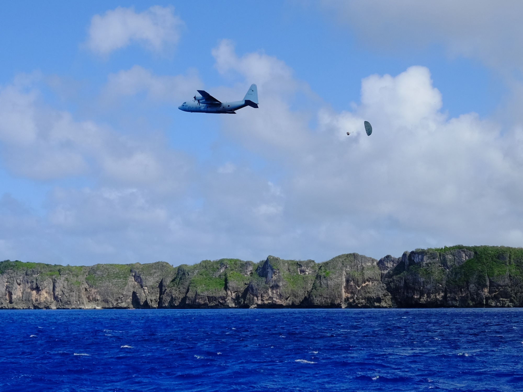 A Japan Air Self-Defense Force C-130H executes a low-cost, low-altitude bundle drop as part of Operation Christmas 2015, Dec. 7, 2015. This year marks the first ever trilateral Operation Christmas Drop where the U.S. Air Force, JASDF and the Royal Australian Air Force work together to provide critical supplies to 56 Micronesian islands while executing partner Humanitarian Aid/Disaster Relief training. (U.S. Air Force photo by Master Sgt. Christopher Bergstrom)