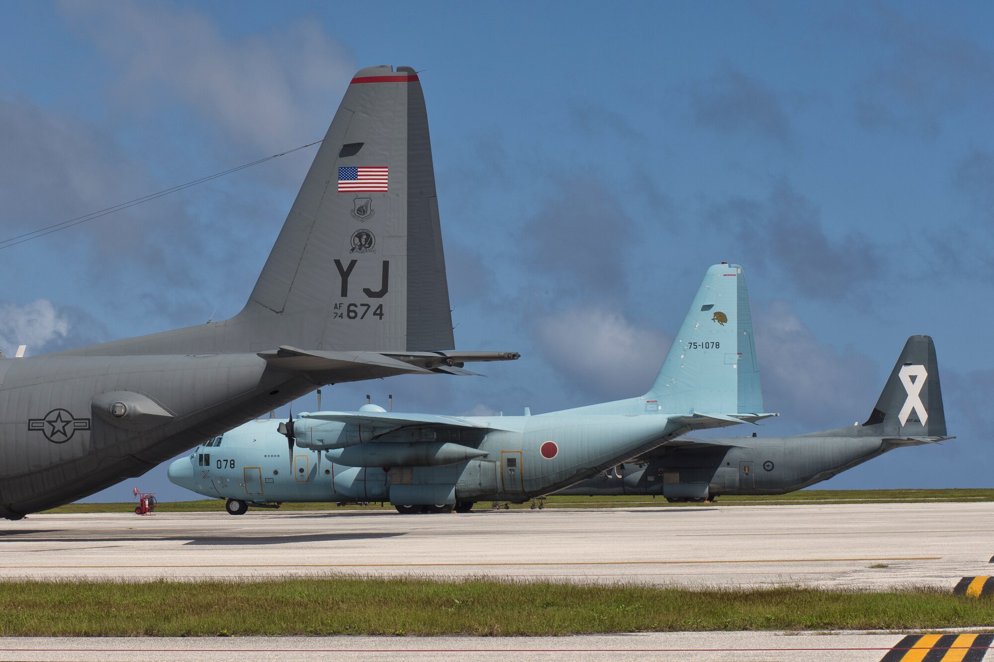 C-130s from the U.S. Air Force, Japan Air Self-Defense Force and Royal Australian Air Force park on the ramp at Andersen Air Force Base, Dec. 6, 2015 in preparation for Operation Christmas Drop. This year marks the 64th year of Operation Christmas Drop, and the first trilateral execution of Department of Defense's longest running humanitarian airdrop mission. (U.S. Air Force photo by Osakabe Yasuo/Released)