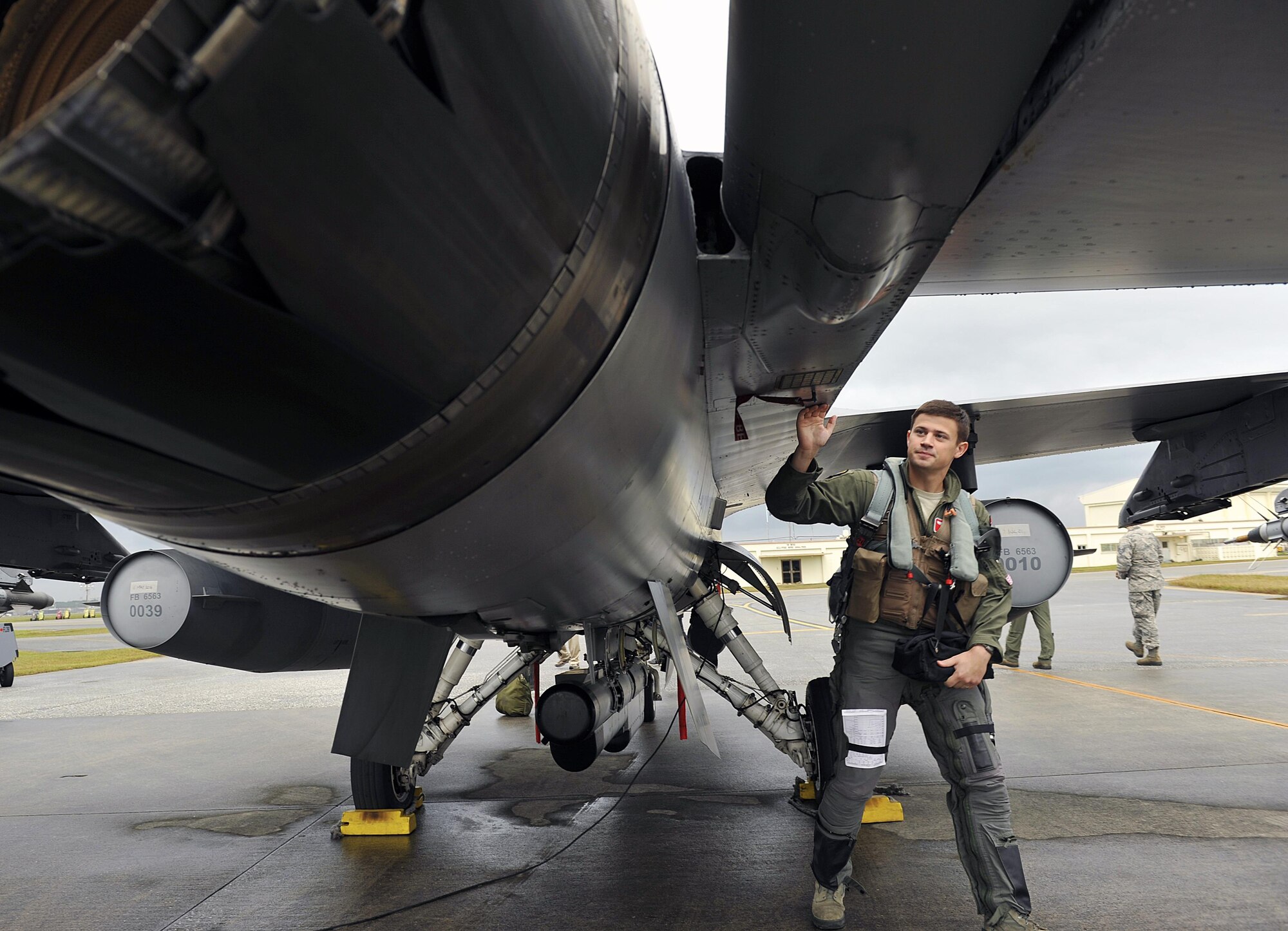 U.S. Air Force 1st Lt. Freddie Dee, 125th Expeditionary Fighter Squadron pilot, performs preflight checks on his F-16 Fighting Falcon before takeoff as part of a U.S. Pacific Command Theater Security Package Dec. 15, 2015, at Kadena Air Base, Japan. TSP deployments are designed to provide the U.S. Pacific Command with forces capable of a variety of operations, including disaster relief, global situational awareness, combating piracy, active defense and power projection. (U.S. Air Force photo by Naoto Anazawa)