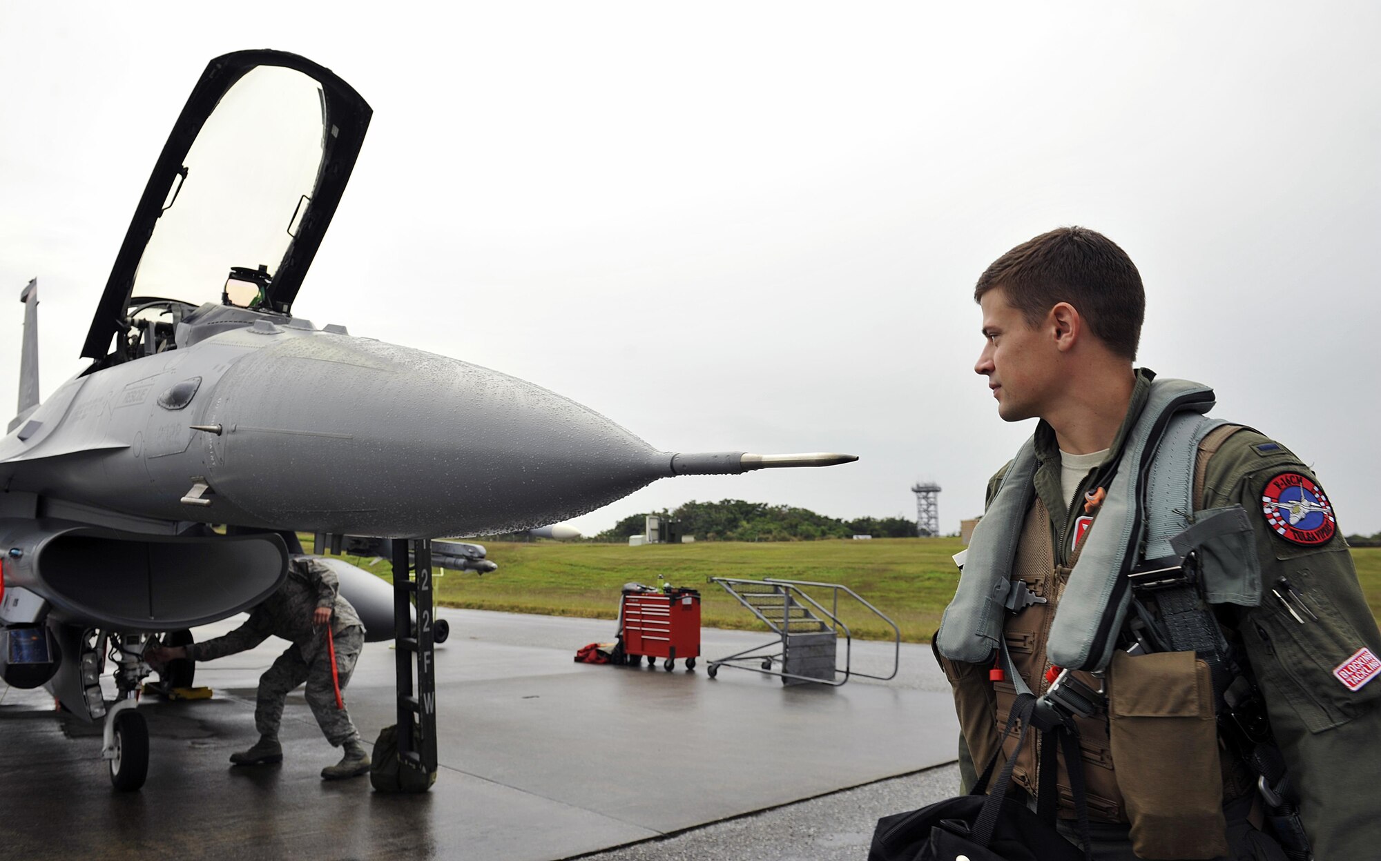 U.S. Air Force 1st Lt. Freddie Dee, 125th Expeditionary Fighter Squadron F-16 Fighting Falcon pilot, completes preflight checks before takeoff for the U.S. Pacific Command Theater Security Package Dec. 15, 2015, at Kadena Air Base, Japan. This TSP demonstrates the continuing U.S. commitment to stability and security in the region and shows our commitment to the U.S.-Japan alliance and the mutual defense of Japan. (U.S. Air Force photo by Naoto Anazawa)