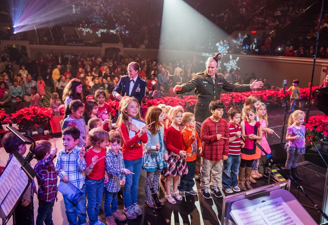 Colonel Larry Lang shows children how to conduct The United States Air Force Band with their candy canes during our Spirit of the Season holiday concert at DAR Constitution Hall. (U.S. Air Force Photo by Senior Master Sgt Kevin Burns/released)