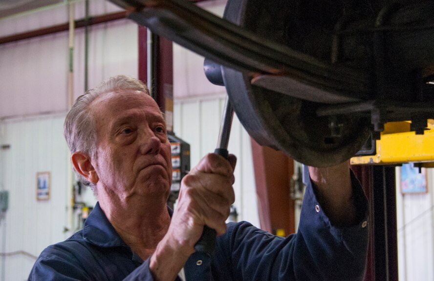 Retired Chief Master Sgt. Bruce Wilson replaces an axle on his 1957 Chevrolet in the F.E. Warren Air Force Base, Wyo., Auto Skills Center Dec. 10, 2015. The base and Laramie County Community College have recently come together to coordinate a plan to allow LCCC students to use the auto skills center for hands-on automotive training. (U.S. Air Force photo by Senior Airman Jason Wiese)