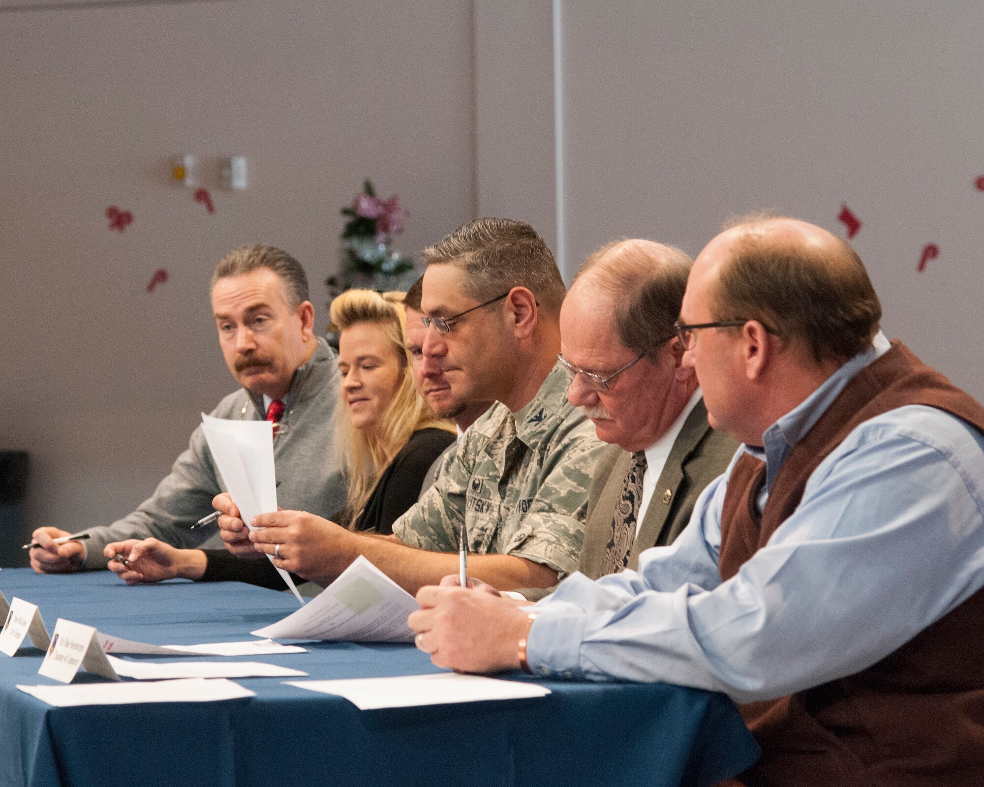 Colonel Stephen Kravitsky , 90th Missile Wing commander; Cheyenne, Wyo., Mayor Rick Kaysen (second from the right); and other members of the F.E. Warren Community Partnership Leadership Committee sign several documents during an Air Force Community Partnership signing event in the Fall Hall Community Center on F.E. Warren Air Force Base, Wyo., Dec. 15, 2015. The committee signed five documents, and more base-community partnership arrangements are in the works. (U.S. Air Force photo by Senior Airman Jason Wiese/Released)