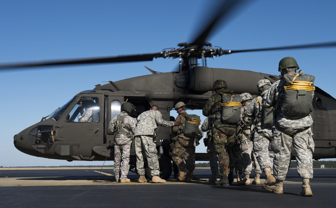U.S. Army paratroopers board a UH-60 Black Hawk helicopter during the Randy Oler Memorial Operation Toy Drop on Camp Mackall, N.C., Dec. 8, 2015. U.S. Air Force photo by Staff Sgt. Douglas Ellis