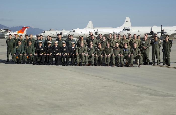 Members of the Japan Maritime Self-Defense Force Air Reconnaissance Squadron VQ-81 and Fleet Air Reconnaissance Squadron VQ-1 pose for a group picture at Marine Corps Air Station Iwakuni, Japan, Dec. 8, 2015. VQ-1 came to MCAS Iwakuni for an annual unit exchange between VQ-1 and VQ-81. The two units discussed their plans to increase their unit interoperability, strengthening the bond between the two units.