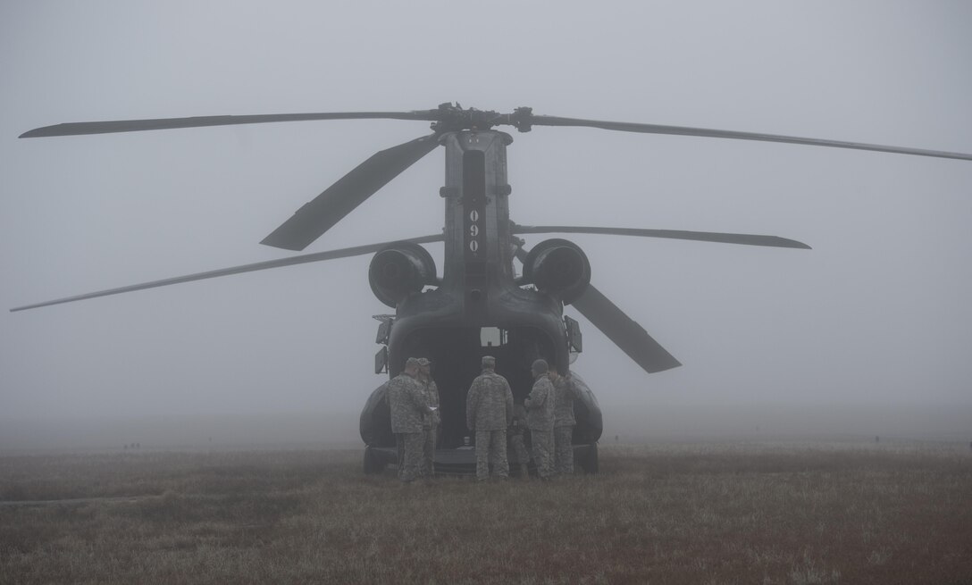 U.S. Army soldiers prepare their CH-47 Chinook helicopter for another day of airborne operations during the Randy Oler Memorial Operation Toy Drop on Camp Mackall, N.C., Dec. 9, 2015. U.S. Air Force photo by Staff Sgt. Douglas Ellis