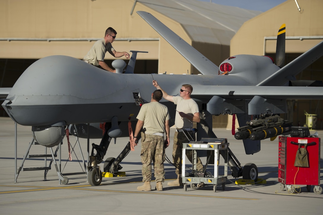 U.S. airmen prepare an MQ-9 Reaper with an extended range modification for a sortie on Kandahar Airfield, Afghanistan, Dec. 5, 2015. The Reaper is an armed, multimission, medium-altitude, long-endurance remotely piloted aircraft used primarily for intelligence collection and against dynamic execution targets. The modification allows for 20 to 40 percent additional flight time. Air Force photo by Tech. Sgt. Robert Cloys