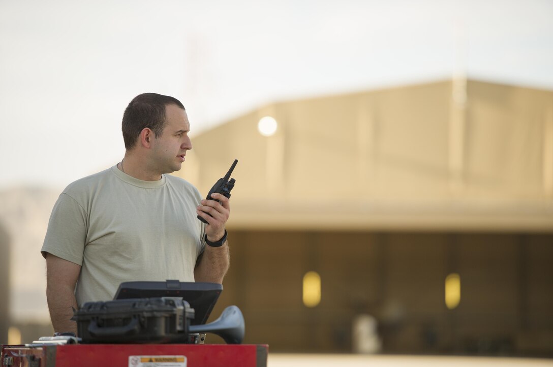 U.S. Air Force Tech. Sgt. Darren radios in the status of an MQ-9 Reaper before a sortie on Kandahar Airfield, Afghanistan, Dec. 5, 2015. Darren is an aircraft specialist assigned to the 62nd Expeditionary Reconnaissance Squadron. U.S. Air Force photo by Tech. Sgt. Robert Cloys