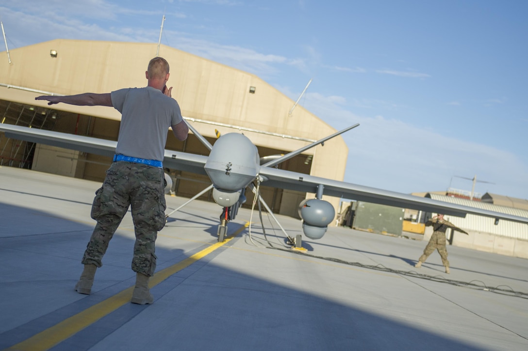 U.S. Air Force Airman 1st Class Landon, left, and U.S. Air Force Airman 1st Class Tyler conduct preflight checks on an MQ-9 Reaper equipped with Gorgon Stare before a sortie on Kandahar Airfield, Afghanistan, Dec. 5, 2015. Landon is an aircraft specialist and Tyler is a crew chief assigned to the 62nd Expeditionary Reconnaissance Squadron. Gorgon Stare provides continuous broad-area motion imagery to find and fix targets. U.S. Air Force photo by Tech. Sgt. Robert Cloys
