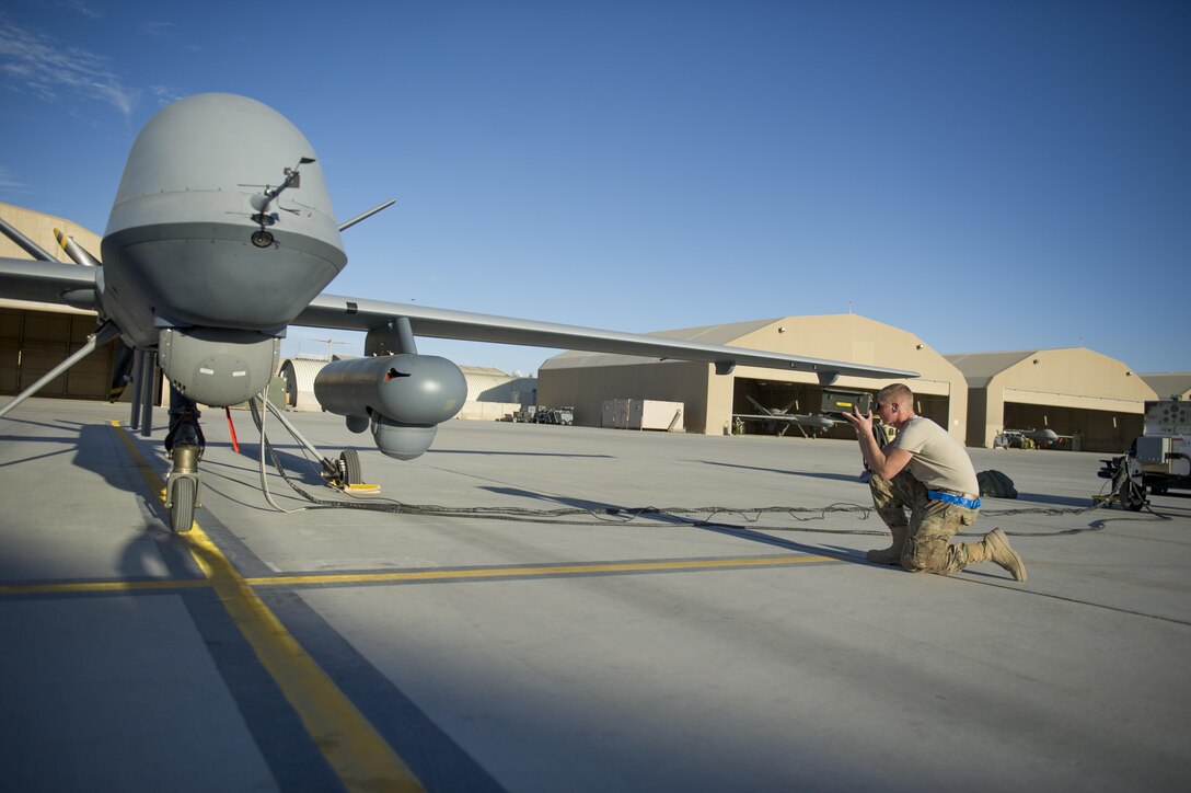 U.S. Air Force Airman 1st Class Landon tests an Identification Friend-or-Foe transponder on an MQ-9 Reaper with Gorgon Stare before a sortie on Kandahar Airfield, Afghanistan, Dec. 5, 2015. Landon is an aircraft specialist assigned to the 62nd Expeditionary Reconnaissance Squadron. U.S. Air Force photo by Tech. Sgt. Robert Cloys