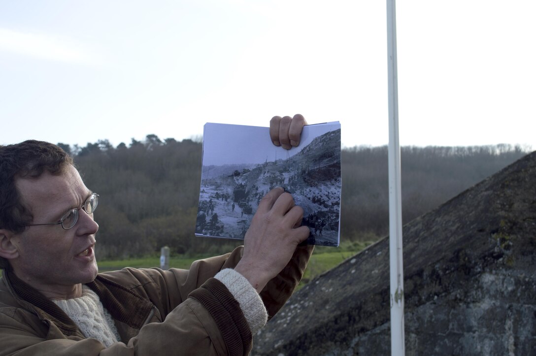 A tour guide shows archived photographs of the historic amphibious Allied landings of D-Day to U.S. Marine noncommissioned officers of U.S. Marine Corps Forces Europe and Africa, Normandy, France, Dec. 11-13. The Marine NCOs are the backbone of service component operations for U.S. European Command that supports numerous NATO-led operations and exercises in Europe that enables the Alliance to continue their proven, enduring partnerships. 