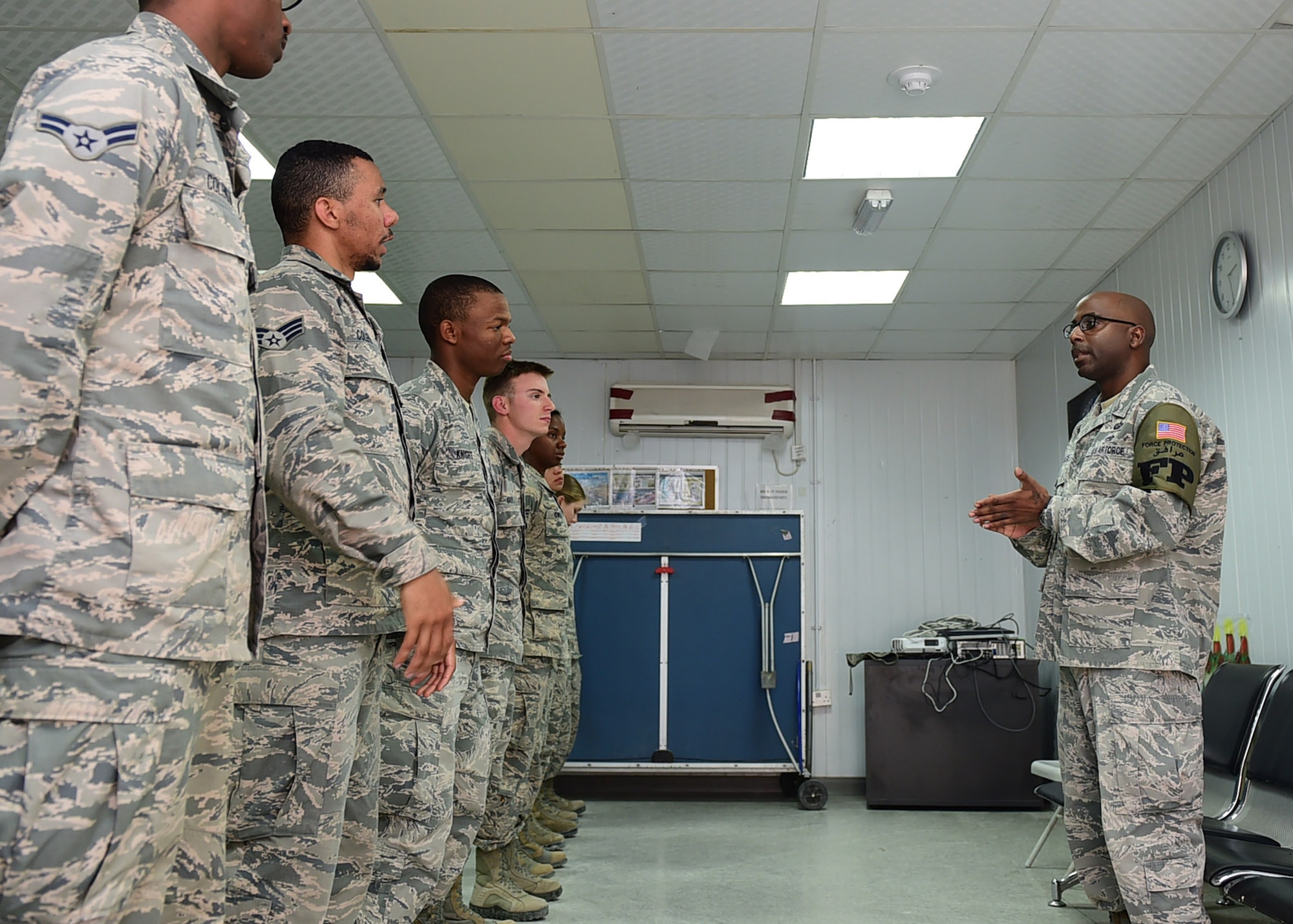 Tech. Sgt. Tyron Fields, a 386th Expeditionary Civil Engineer Squadron Force Protection shift lead, speaks to Airmen during roll call at an undisclosed location in Southwest Asia, Dec. 16, 2015. Fields co-founded a mentorship program aimed to help troubled youth in his hometown of Charleston, South Carolina. Fields is currently deployed to the 386th AEW in support of Operation INHERENT RESOVE. (U.S. Air Force photo by Staff Sgt. Jerilyn Quintanilla)