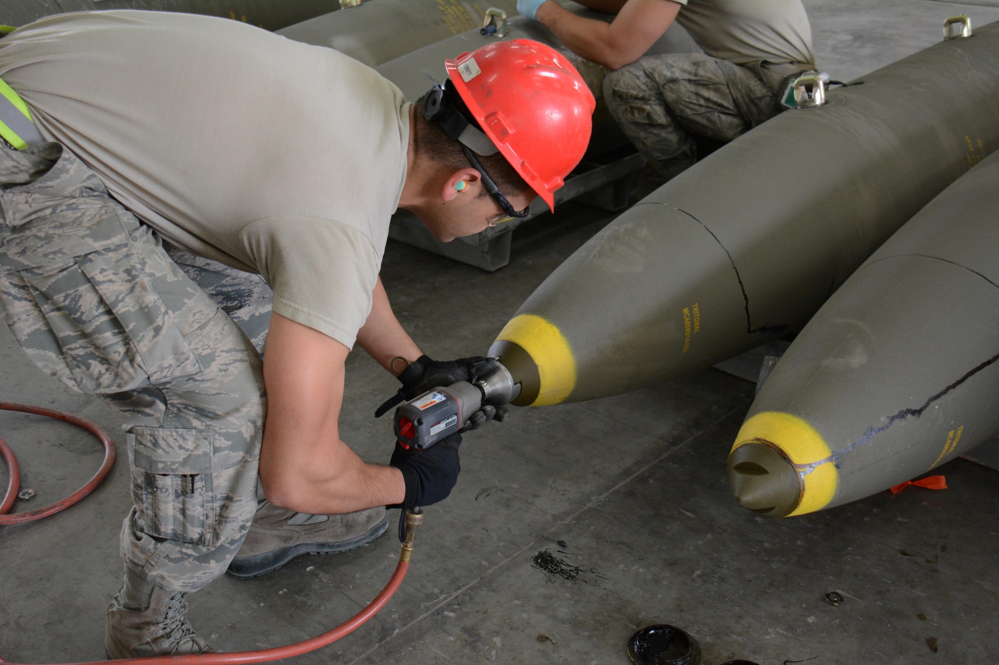 Airman 1st Class Ralph Pangilinan, 379th Expeditionary Maintenance Squadron Munitions Flight, prepares a joint attack direct munition for transport at Al Udeid Air Base, Qatar Dec. 17. Pangilinan, a native of San Diego, California, is a part of a record-setting munitions team that has built nearly 4,000 bombs since July 2015. (U.S. Air Force photo by Tech. Sgt. James Hodgman/Released)
