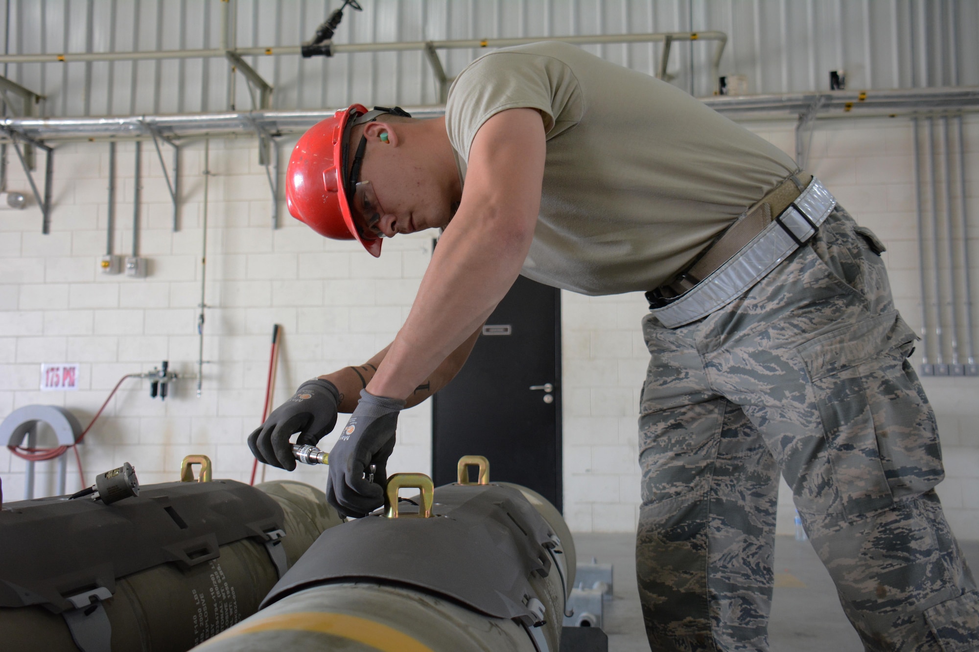 Staff Sgt. Daniel Eisenhart, 379th Expeditionary Maintenance Squadron Munitions Flight, prepares a joint attack direct munition for transport at Al Udeid Air Base, Qatar Dec. 17. Eisenhart, a native of Hanover, Pennsylvania, is a part of a record-setting munitions team that has built nearly 4,000 bombs since July 2015. (U.S. Air Force photo by Tech. Sgt. James Hodgman/Released)