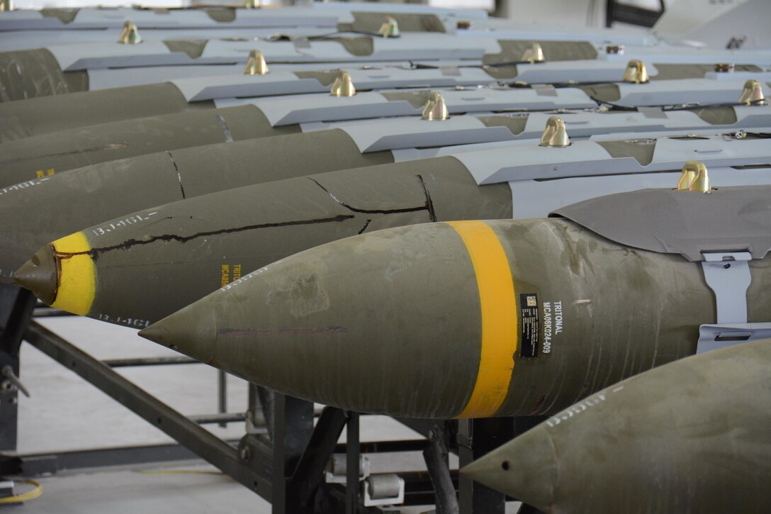 A dozen 2,000-pound joint direct attack munitions sit inside a warehouse at Al Udeid Air Base, Qatar Dec. 17. The bombs were built by hand by airmen from the 379th Expeditionary Maintenance Squadron’s Munitions Flight. The Munitions Flight has built nearly 4,000 bombs since July 2015. (U.S. Air Force photo by Tech. Sgt. James Hodgman/Released)