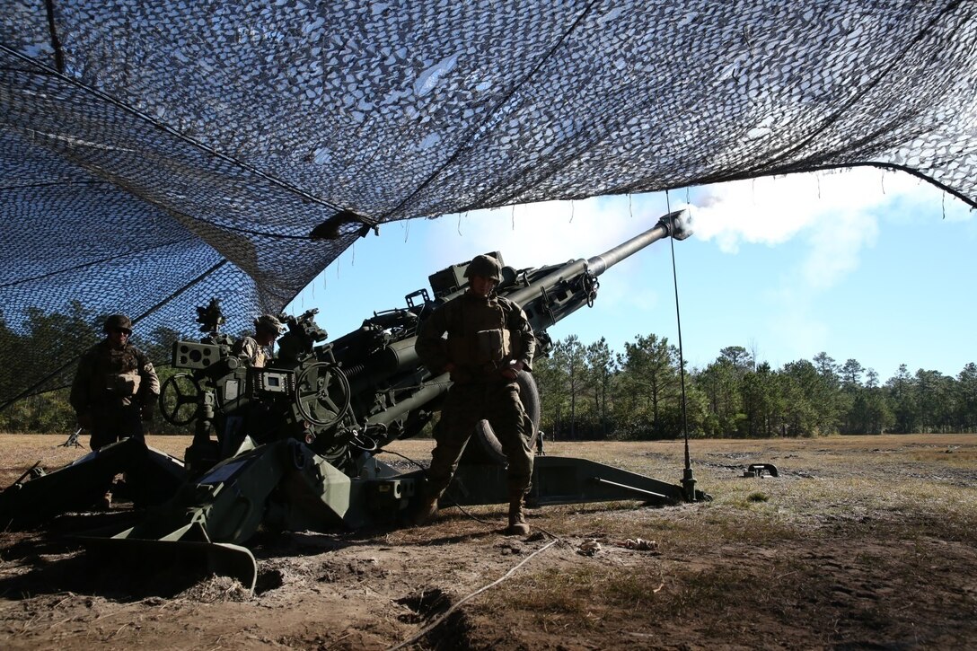 Marines with Charlie Battery, 1st Battalion, 10th Marine Regiment, fire an M777A2 howitzer during a gunnery precision and calibration exercise at Camp Lejeune, N.C., Dec. 15, 2015. The M777A2 has an unassisted range of 15 miles. The Marines conducted the training to solidify team cohesion and enhance their readiness to complete live-fire missions in preparation for Exercise Cold Response 16. Cold Response 16 is a multinational, Norwegian-led exercise that prepares more than 15,000 troops from 16 countries for support and combat operations in harsh conditions while working together to create stronger bonds between the allied forces.  (U.S. Marine Corps photo by Lance Cpl. Shannon Kroening/Released)