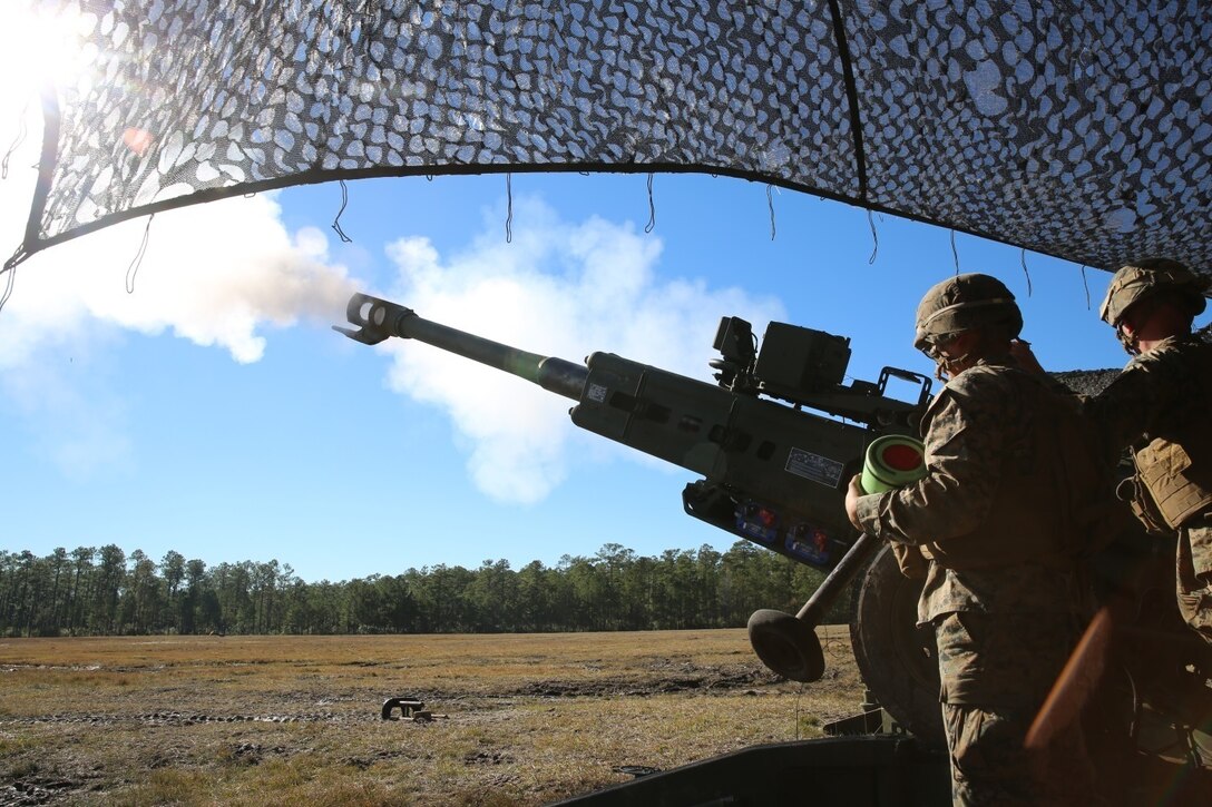 Marines with Charlie Battery, 1st Battalion, 10th Marine Regiment, fire the first round of the day out of an M777A2 howitzer, during a gunnery precision and calibration exercise at Camp Lejeune, N.C., Dec. 15, 2015. The Marines conducted the training to solidify team cohesion and enhance their readiness to complete live-fire missions in preparation for Exercise Cold Response 16. Cold Response 16 is a multinational, Norwegian-led exercise that prepares more than 15,000 troops from 16 countries for support and combat operations in harsh conditions while working together to create stronger bonds between the allied forces.  (U.S. Marine Corps photo by Lance Cpl. Shannon Kroening/Released)