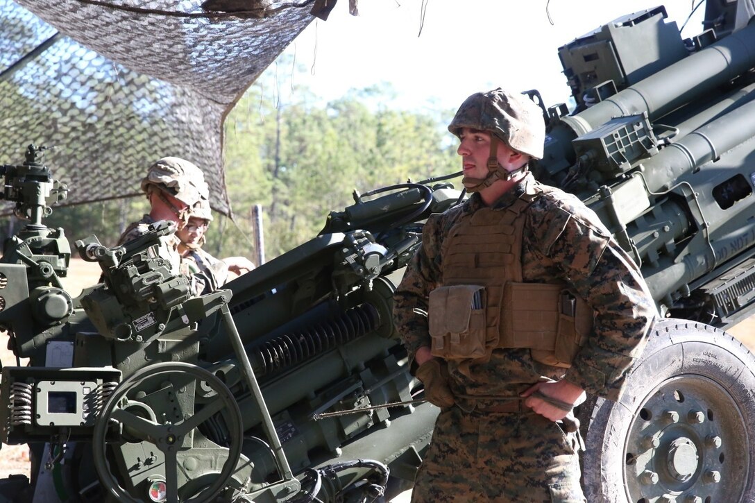 Cpl. Alexander McAvoy, a field artillery cannoneer with Charlie Battery, 1st Battalion, 10th Marine Regiment, waits for the command to fire the M777A2 howitzer during a gunnery precision and calibration exercise at Camp Lejeune, N.C., Dec. 15, 2015. McAvoy’s job is to fire the howitzer by pulling the lanyard upon command from the section chief. The Marines conducted the training to solidify team cohesion and enhance their readiness to complete live-fire missions in preparation for Exercise Cold Response 16. Cold Response 16 is a multinational, Norwegian-led exercise that prepares more than 15,000 troops from 16 countries for support and combat operations in harsh conditions while working together to create stronger bonds between the allied forces.  (U.S. Marine Corps photo by Lance Cpl. Shannon Kroening/Released)