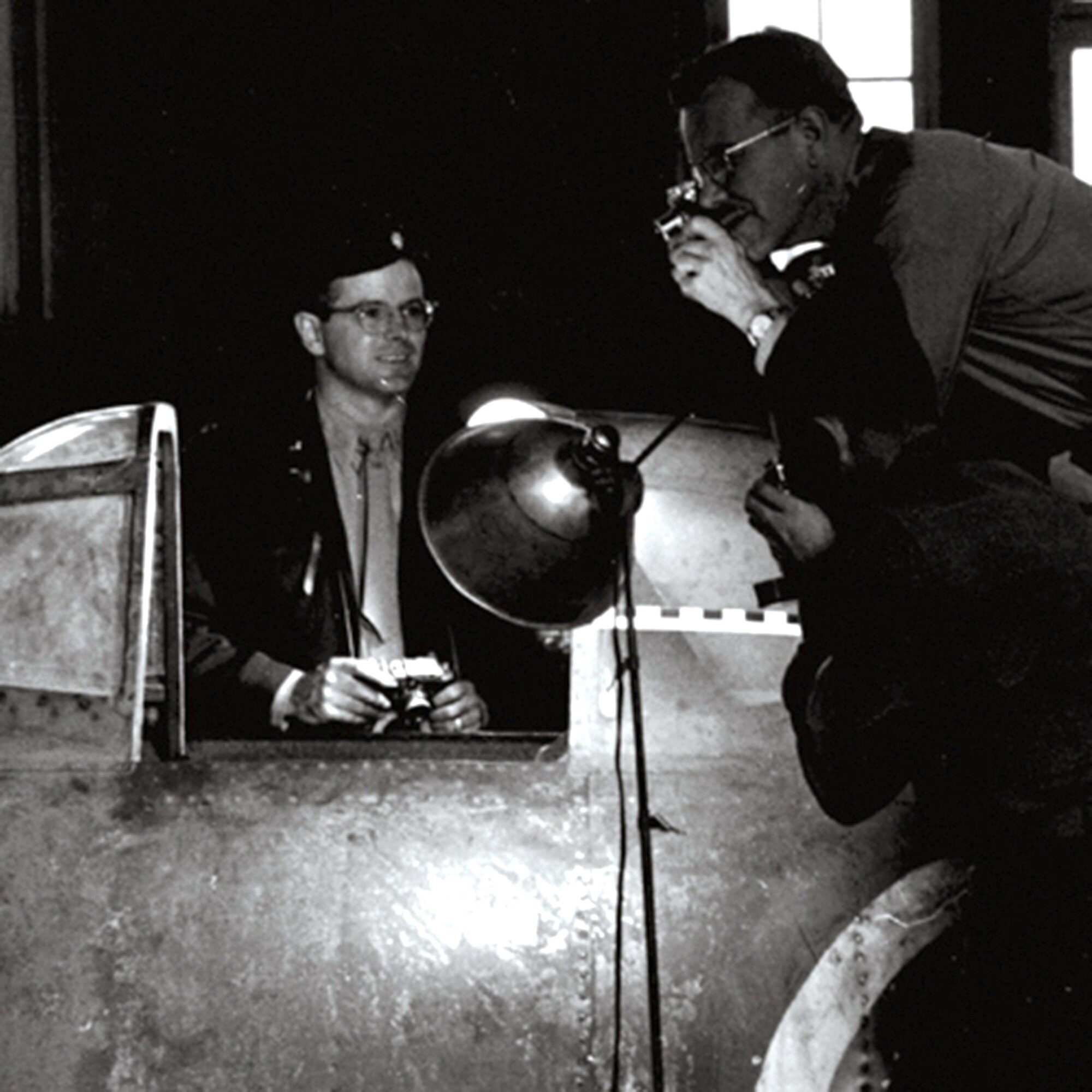 Victor Bilek (left), then a major in the Army Air Forces, takes images of a catured Japanese aircraft at during World War II Wright Field, Ohio. Bilek, now 97 years old, is the oldest living National Air and Space Intelligence Center alum. Then it was know as T-2 Intelligence. (U.S. Air Force courtesy photo)