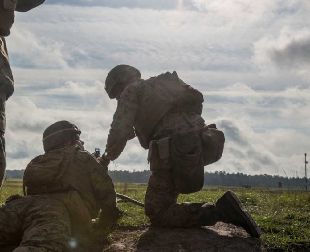 Marines with 1st Battalion, 8th Marine Regiment pause and check for a weapons malfunction during a company live-fire exercise aboard Camp Lejeune, N.C., Sept. 30, 2015. The exercise is in preparation for the integrated training exercise taking place at Air-Ground Combat Center Twentynine Palms, Calif., next month. (U.S. Marine Corps photo by Lance Cpl. Immanuel Johnson/Released)