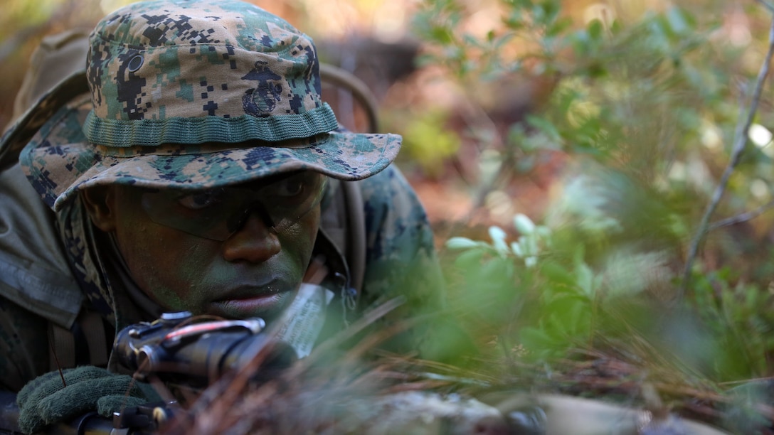 Pfc. Jean Joseph, a rifleman with 2nd Light Armored Reconnaissance Battalion holds a security position during a patrolling exercise at Marine Corps Base Camp Lejeune, N.C., Dec 15, 2015. The unit practiced patrolling techniques and set up patrol bases to maintain readiness. 