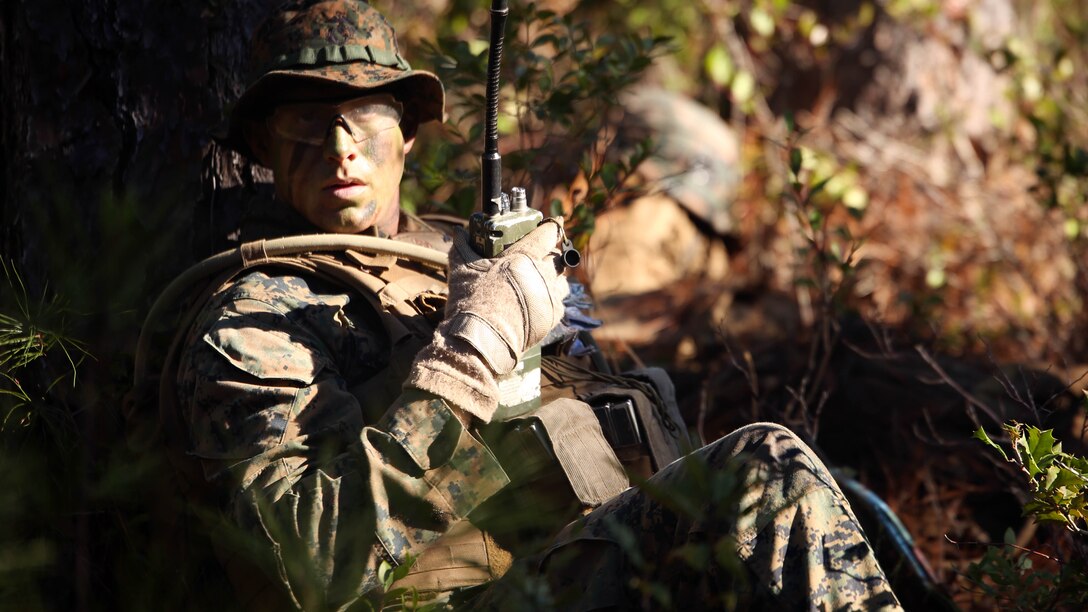Lance Cpl. Silas Lewis, a rifleman with 2nd Light Armored Reconnaissance Battalion communicates grid coordinates during a patrolling exercise at Marine Corps Base Camp Lejeune, N.C., Dec 15, 2015. The unit practiced patrolling techniques and set up patrol bases to maintain readiness. 