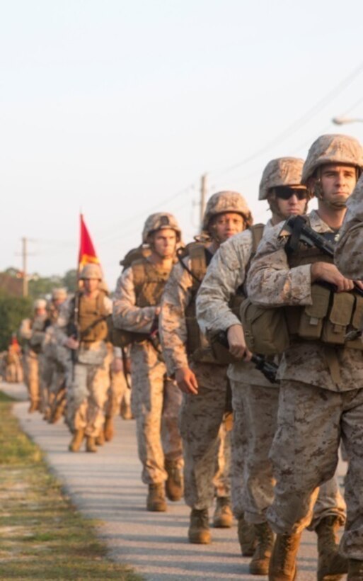 Marines with 8th Communications Battalion, II Marine Expeditionary Force, participate in a conditioning hike aboard Camp Lejeune, N.C., Sept. 4, 2015. Each Marine carried canned goods for a local homeless shelter during the conditioning hike and dropped them off at a collection point halfway through the march. (U.S. Marine Corps photo by Lance Cpl. Immanuel Johnson/Released)