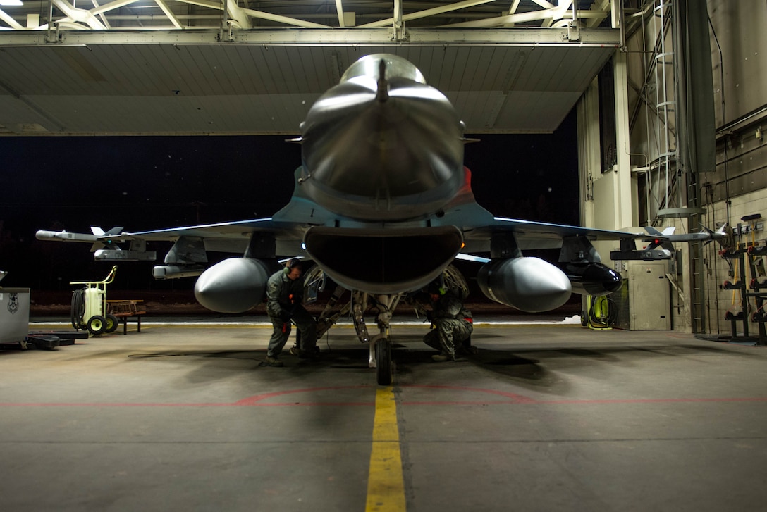 Air Force Staff Sgts. Robert Knickle, left, and Timothy Smith perform final preflight checks on an F-16 Fighting Falcon aircraft on Eielson Air Force Base, Alaska, Dec. 7, 2015. U.S. Air Force photo by Staff Sgt. Shawn Nickel