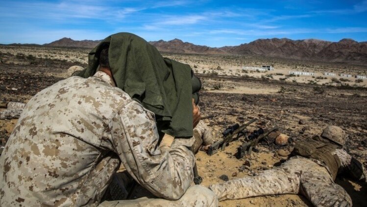 A Marine with 1st Battalion, 8th Marine Regiment observes snipers engaging targets during the sniper marksmanship assessment as part of Integrated Training Exercise 1-16 at Marine Corps Air Ground Combat Center, Twentynine Palms, Calif., Oct. 24, 2015. During ITX, Marines demonstrate core infantry mission essential tasks while conducting offensive and defensive stability operations.