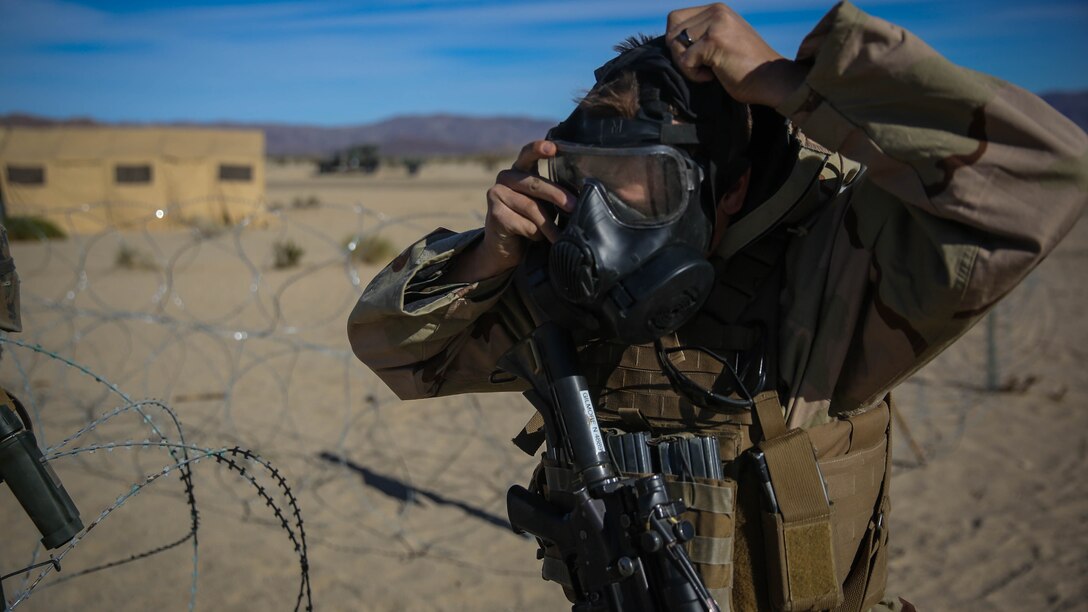 A Marine with 5th Marine Regiment, 1st Marine Division, dons his gas mask during a chemical, biological, radiological, nuclear drill designed to familiarize the Marines with immediate actions aboard Marine Corps Air Ground Combat Center Twentynine Palms, Calif., Dec. 13, 2015. The Marines and Sailors with 5th Marine Regiment conducted the gas drill as part of Steel Knight 2016, a division-led exercise which prepares Marines and Sailors with the 1st Marine Division and adjacent I Marine Expeditionary Force units with the skill sets necessary to operate as a fully capable Marine Air Ground Task Force. 