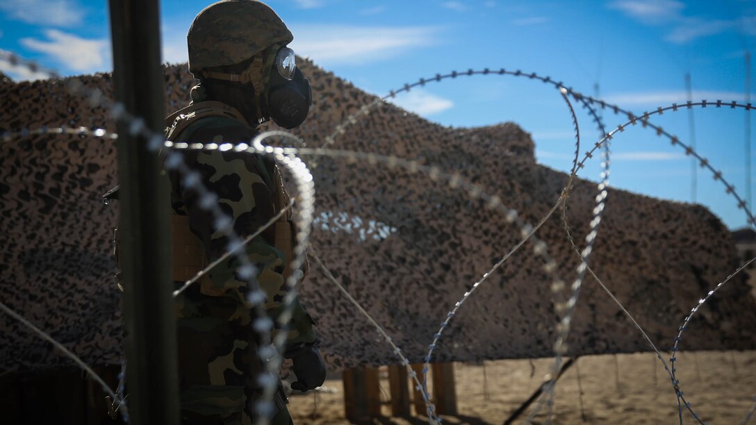 A Marine with 5th Marine Regiment, 1st Marine Division, checks the perimeter of the combat operations center during a chemical, biological, radiological, nuclear drill designed to familiarize the Marines with immediate actions aboard Marine Corps Air Ground Combat Center Twentynine Palms, California, Dec. 13, 2015. The Marines and Sailors with 5th Marine Regiment conducted the gas drill as part of Steel Knight 2016, a division-led exercise which prepares Marines and Sailors with the 1st Marine Division and adjacent I Marine Expeditionary Force units with the skill sets necessary to operate as a fully capable Marine Air Ground Task Force.  