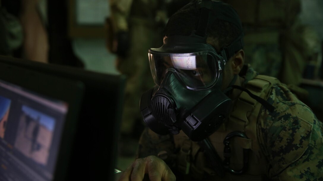 Lance Cpl. Roderick Jacquote, a combat photographer with Headquarters Company, Headquarters Battalion, 1st Marine Division, edits photos during a chemical, biological, radiological, nuclear drill aboard Marine Corps Air Ground Combat Center Twentynine Palms, California, Dec. 13, 2015. The Marines and Sailors with 5th Marine Regiment conducted the gas drill as part of Steel Knight 2016, a division-led exercise which prepares Marines and Sailors with the 1st Marine Division and adjacent I Marine Expeditionary Force units with the skill sets necessary to operate as a fully capable Marine Air Ground Task Force.  